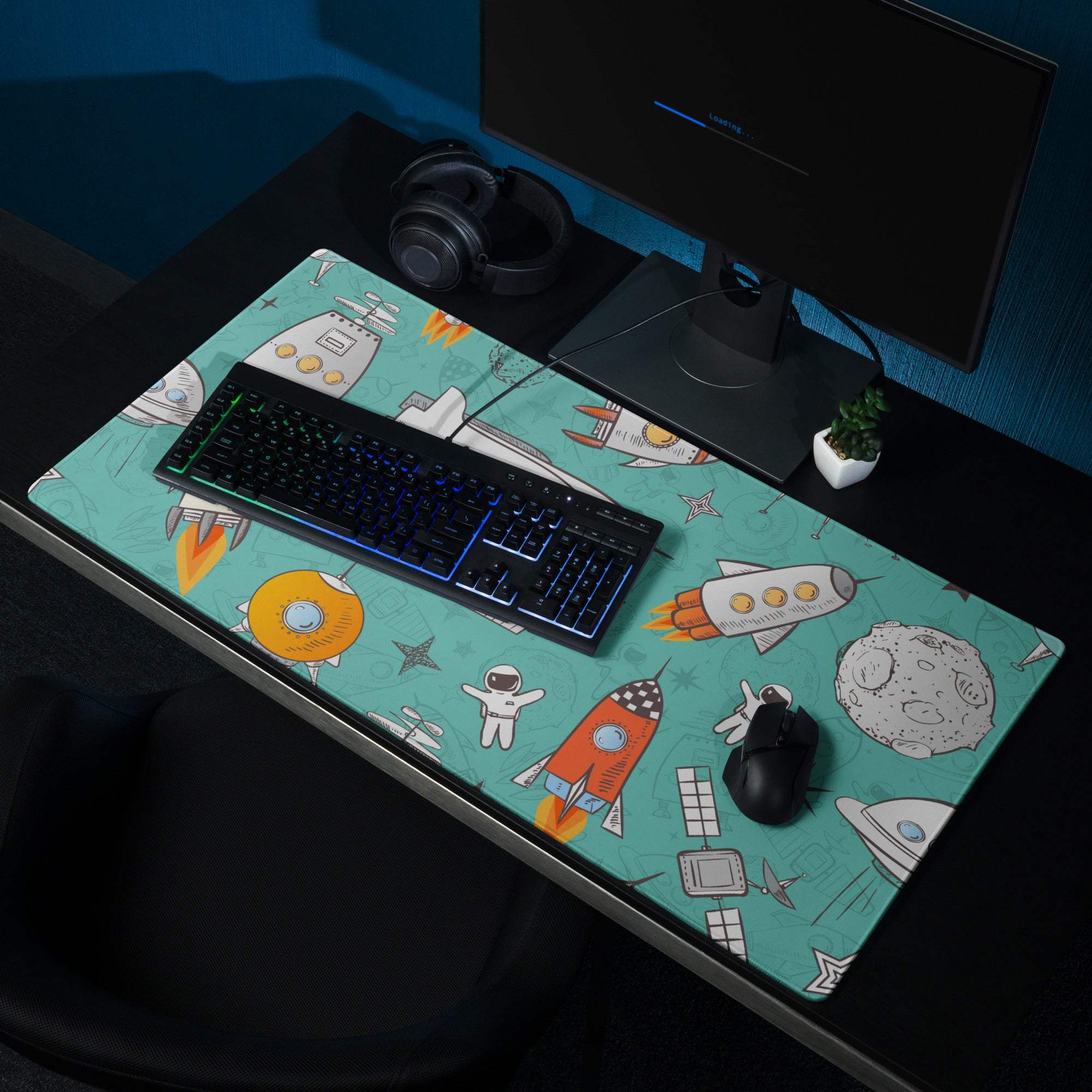 Teal space gaming mouse pad with rockets, astronauts, planets, non-slip base