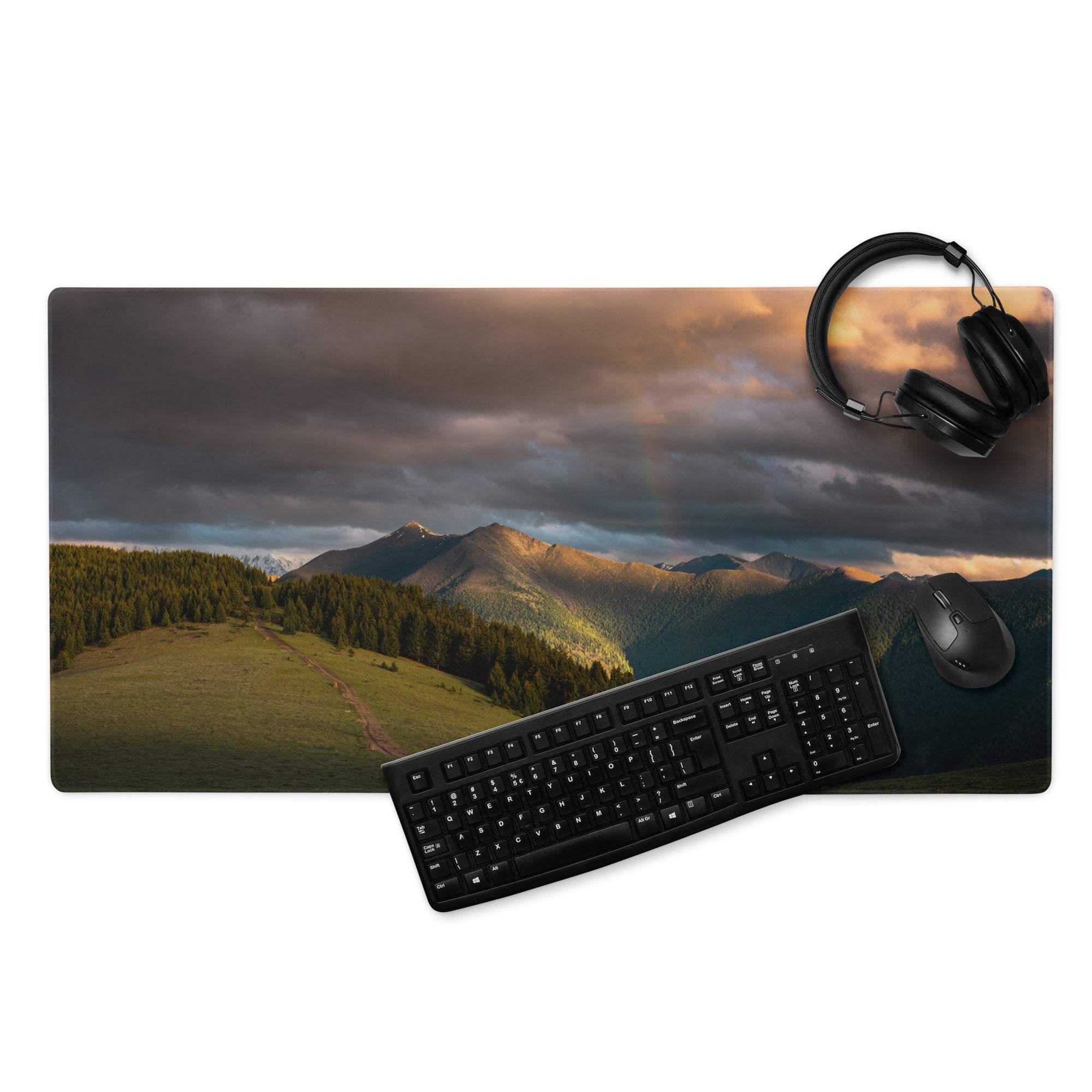 Black keyboard and mouse on epic mountain sunset gaming mousepad