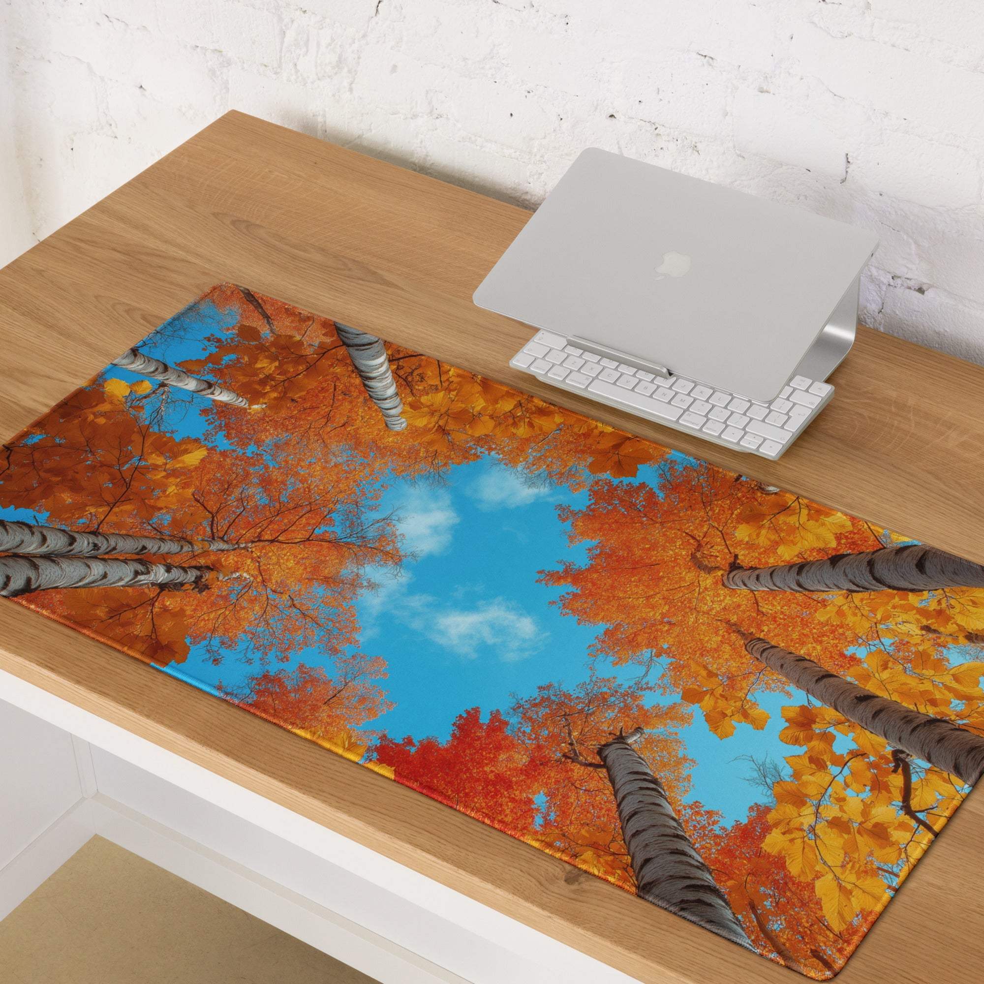 Autumn forest gaming mouse pad with vibrant orange foliage and blue sky