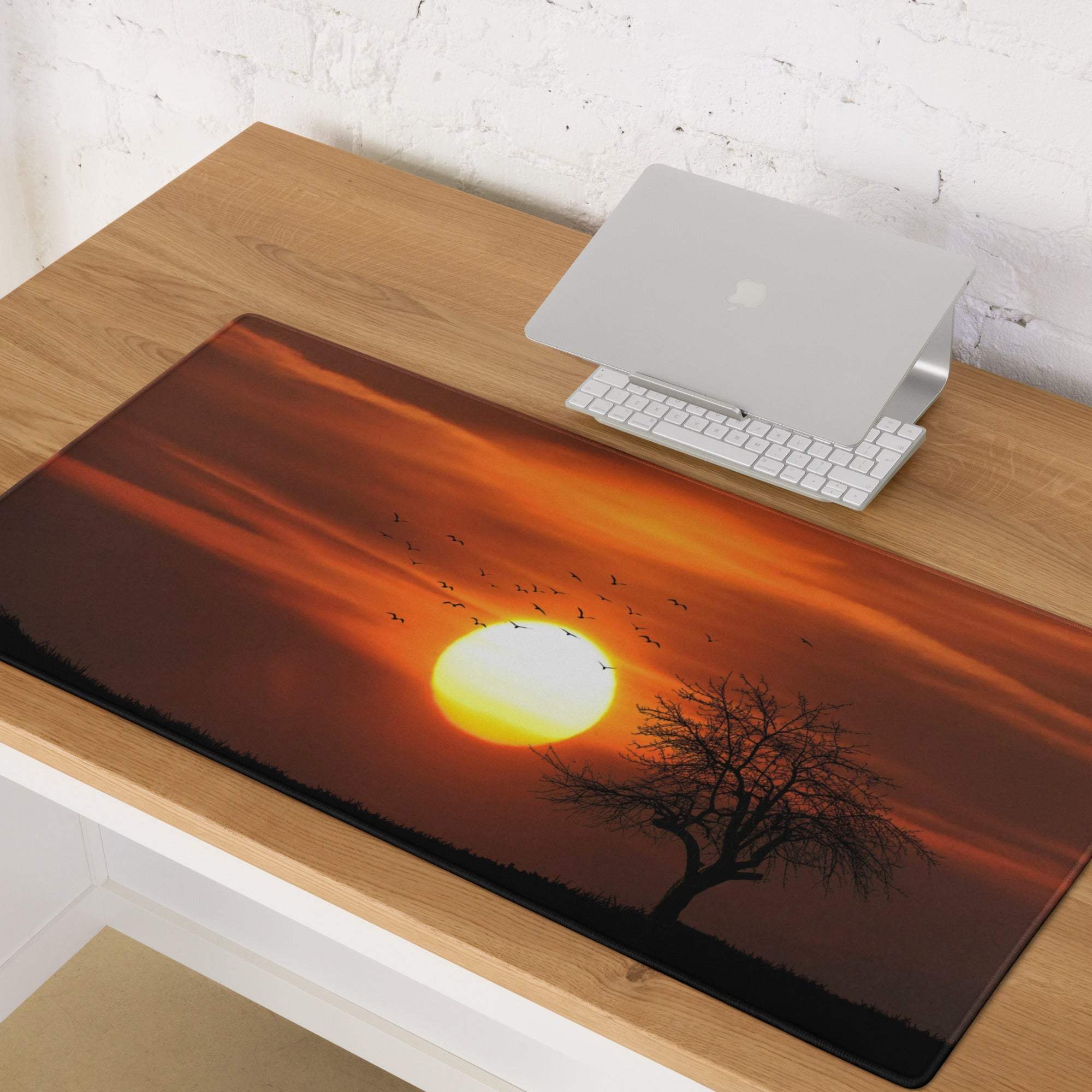 Warm sunset gaming mouse pad with vivid orange sun, birds, tree silhouette