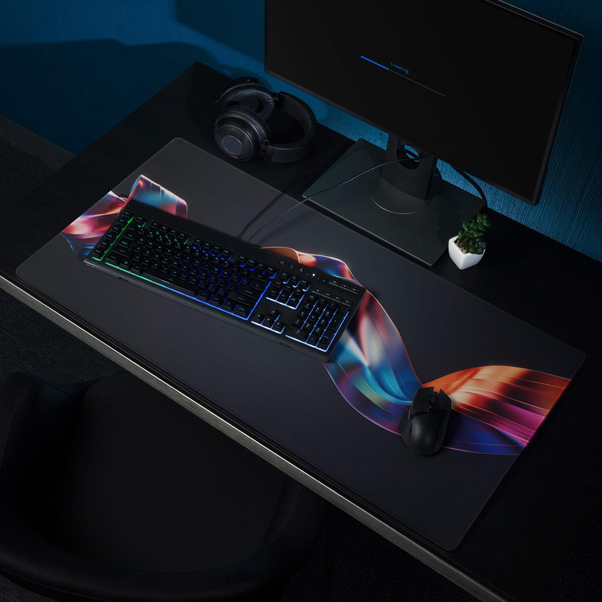 Black gaming mousepad with vibrant rainbow ribbon design and stitched edges