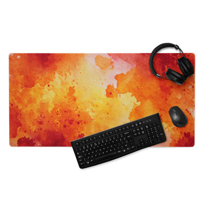 Orange watercolor splash gaming mousepad with black keyboard and headphones