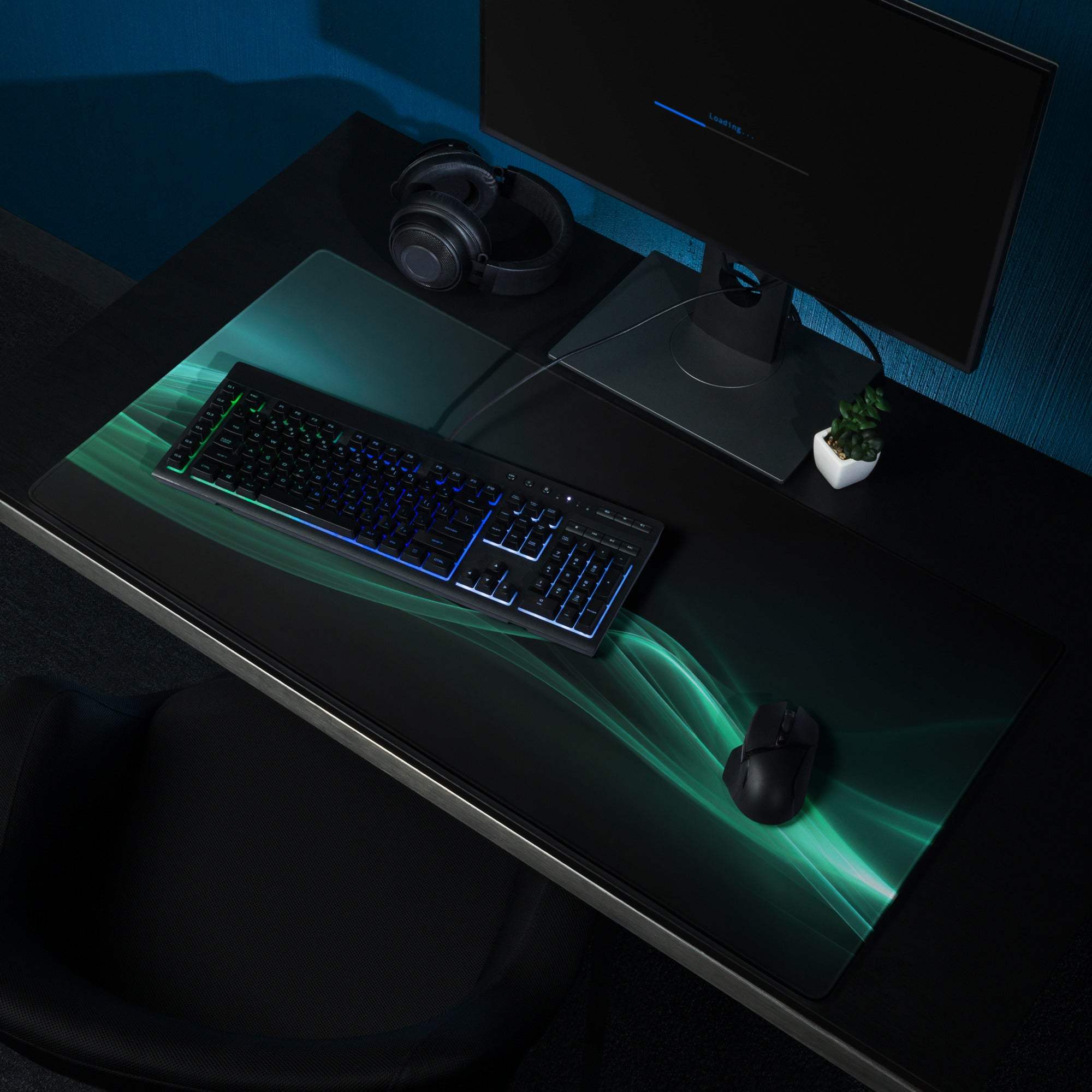 Black gaming mousepad with glowing teal wave pattern and edge stitching