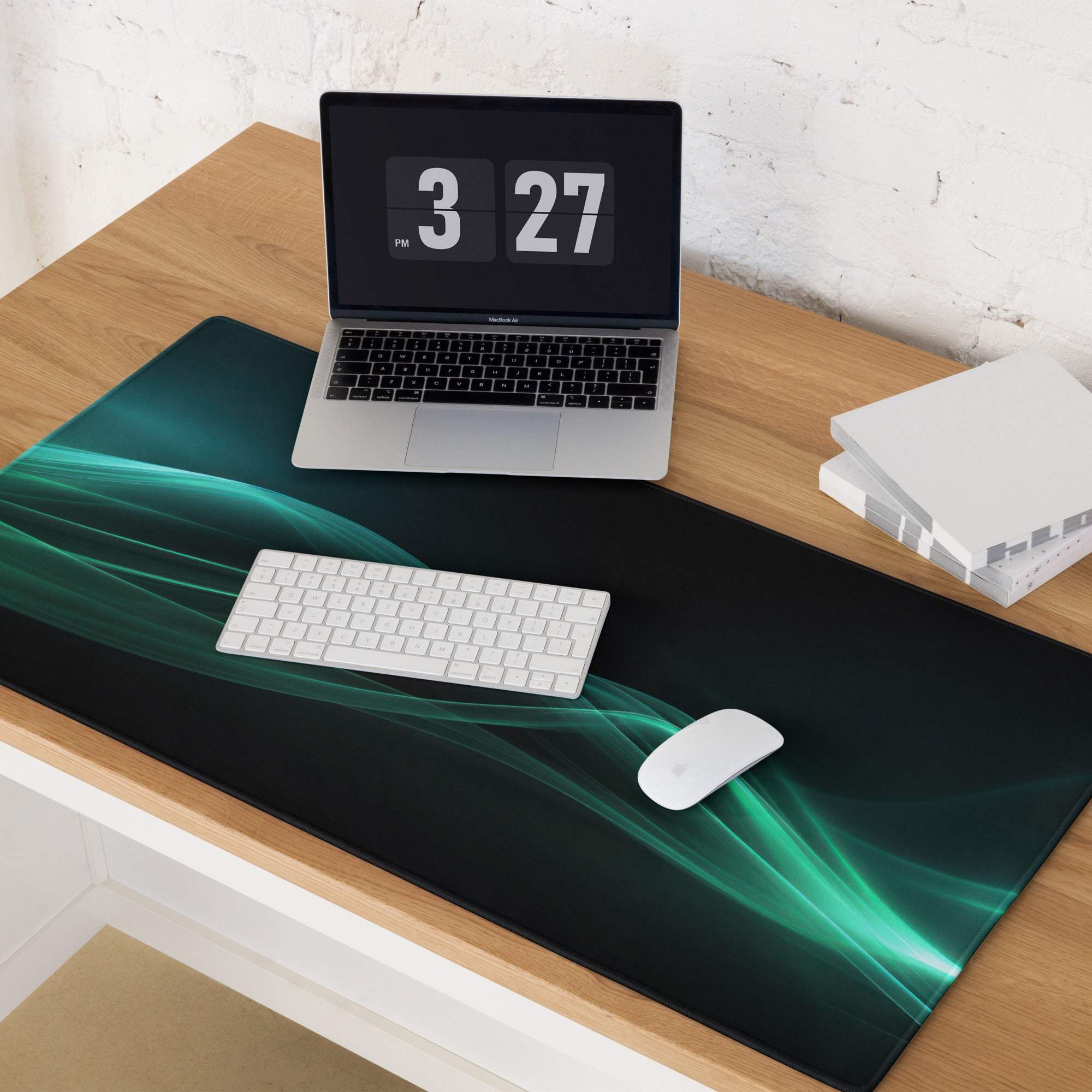 Sleek teal wave gaming mouse pad on black with non-slip edge stitching