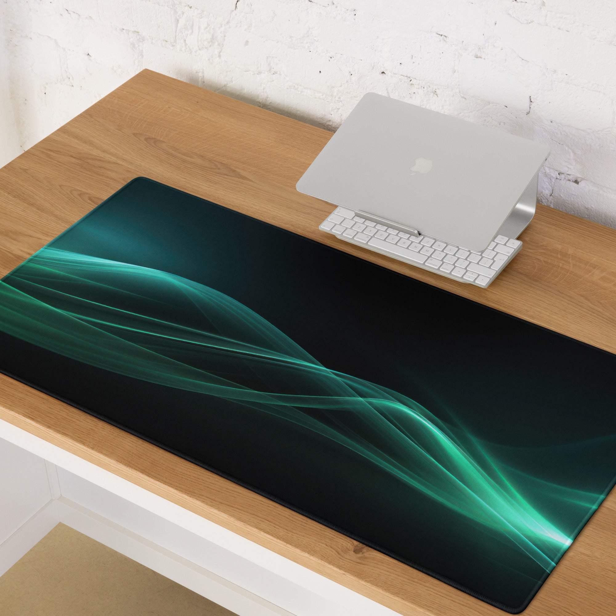 Sleek black gaming mouse pad with glowing teal waves, non-slip edge stitching, large size