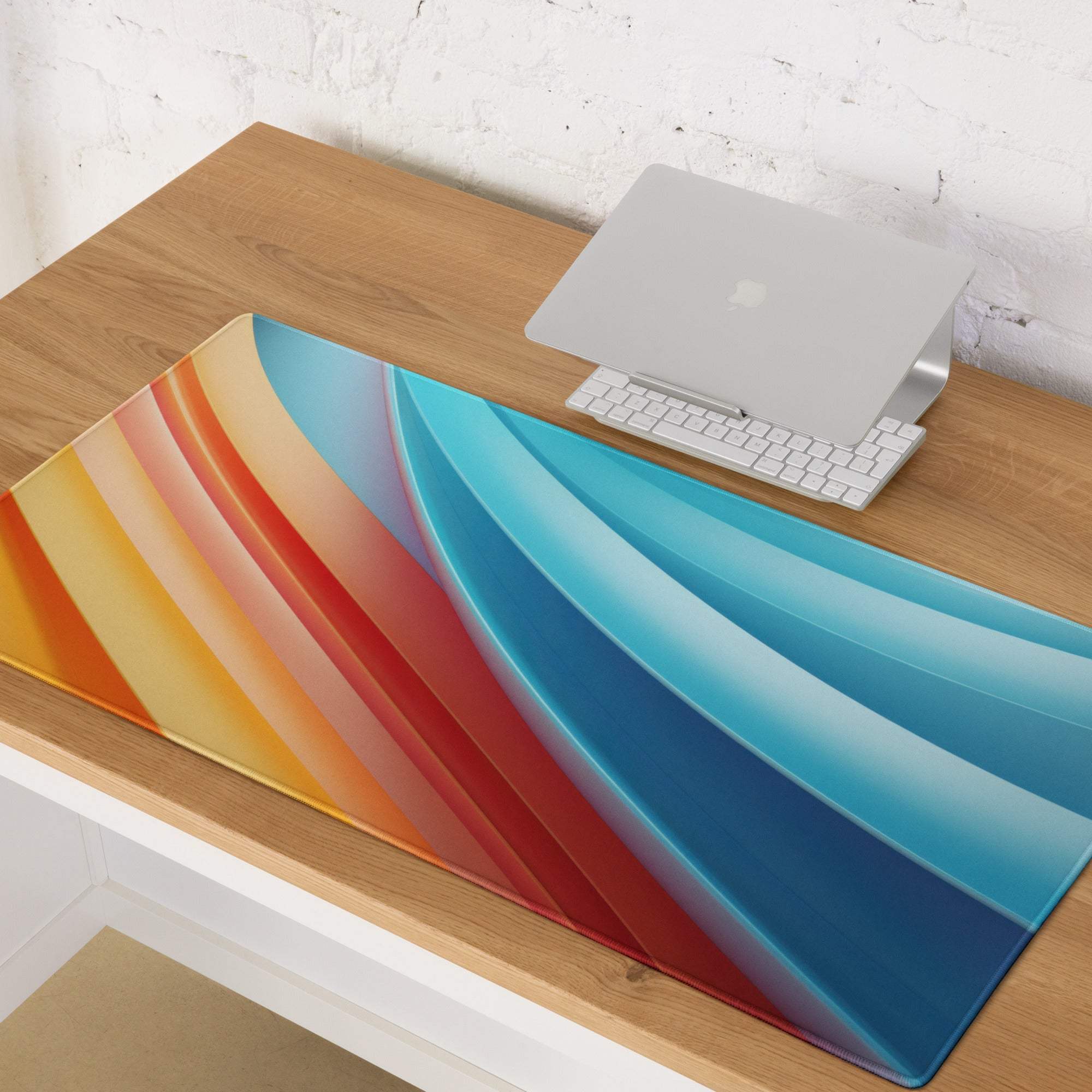 Vibrant gradient large gaming mouse pad with orange-to-blue stripes, non-slip base, stitched edges