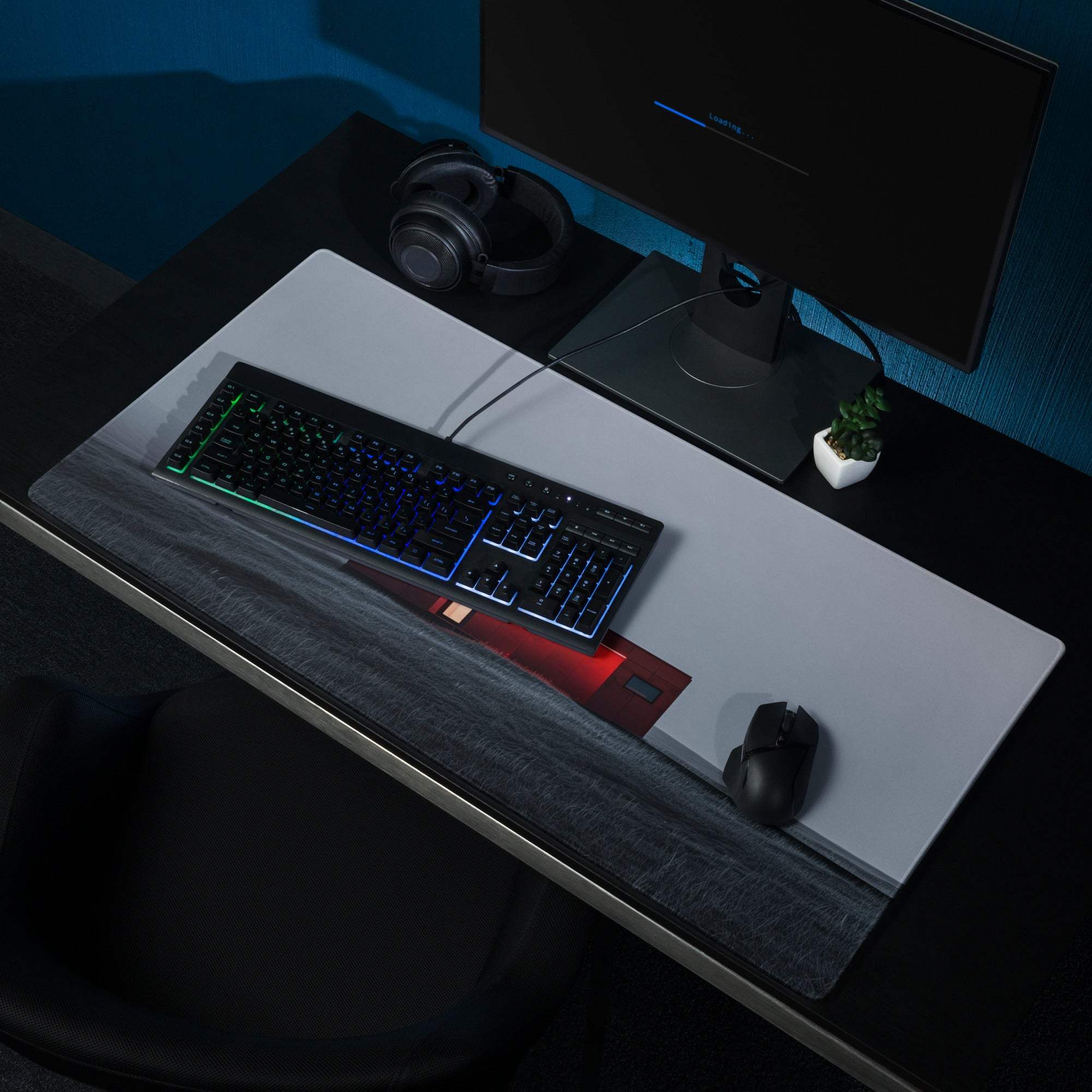 Black RGB keyboard on minimalist red dusk gaming mouse pad with wrist rest