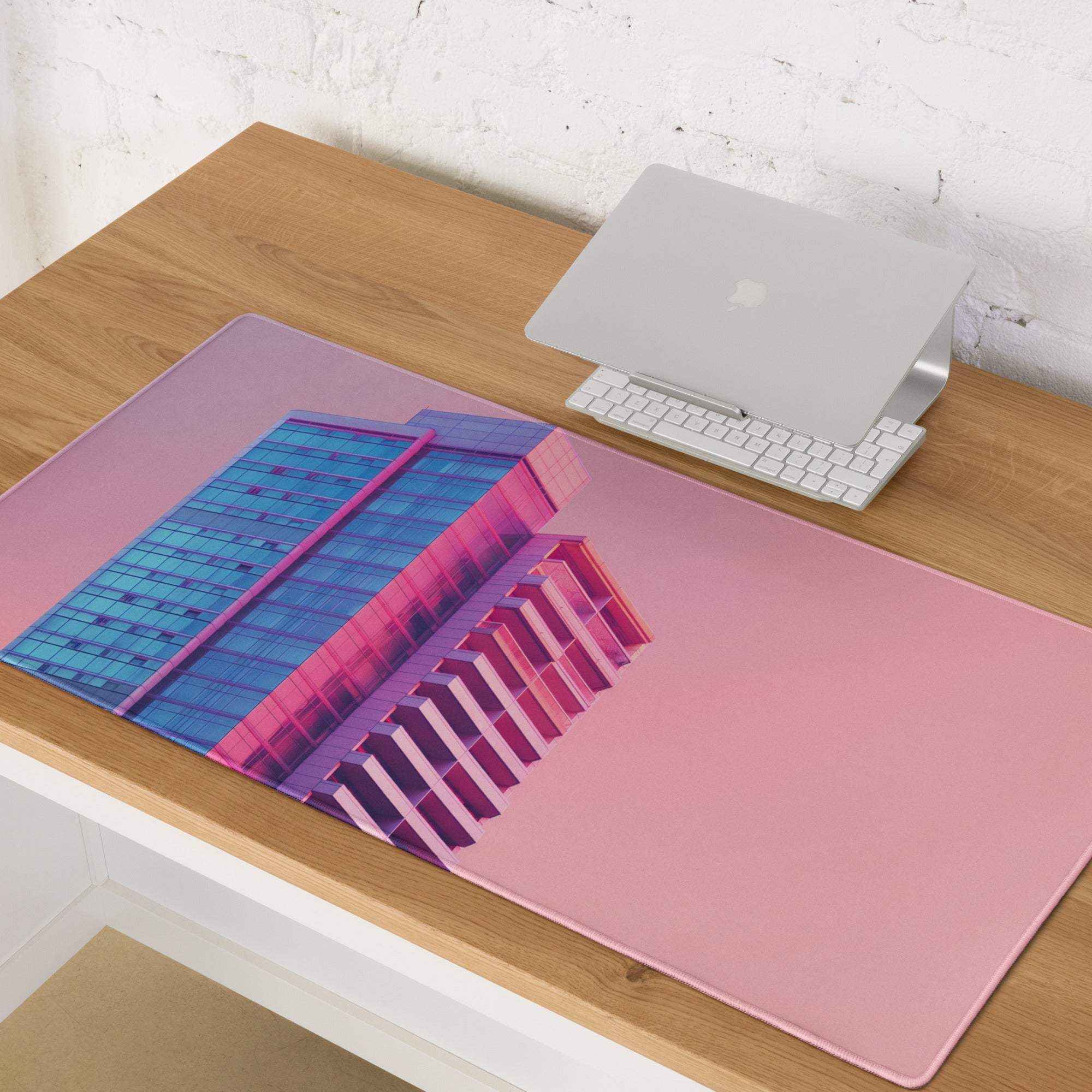 Neon pink gradient cityscape gaming mouse pad with blue magenta glass building