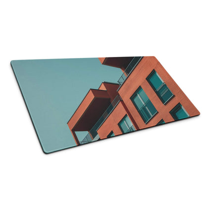 Sleek gaming mouse pad with terracotta brick architecture and teal windows