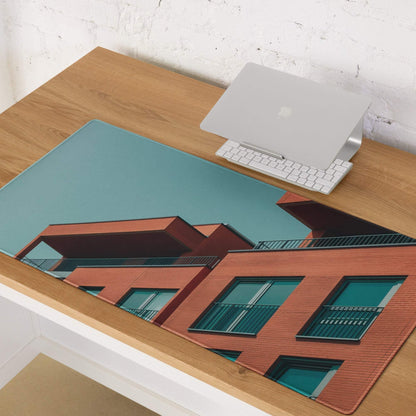Sleek large edge-stitched gaming mouse pad with red brick architectural print and teal sky
