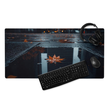 Black rectangular mousepad with autumn leaf in rain puddle and city reflections