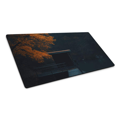 Moody autumn forest gaming mouse pad with glowing orange leaves photo