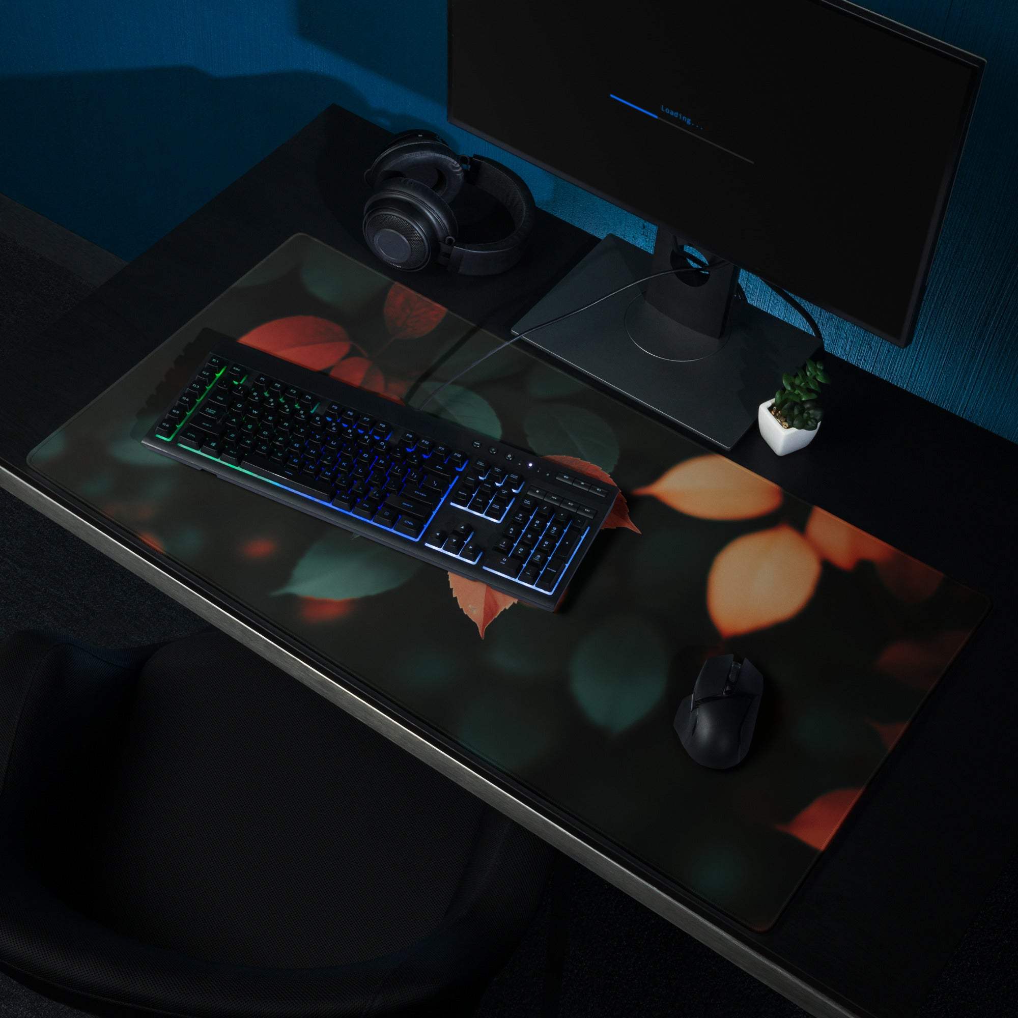 Sleek black Autumn Leaves gaming mousepad with glowing orange teal accents