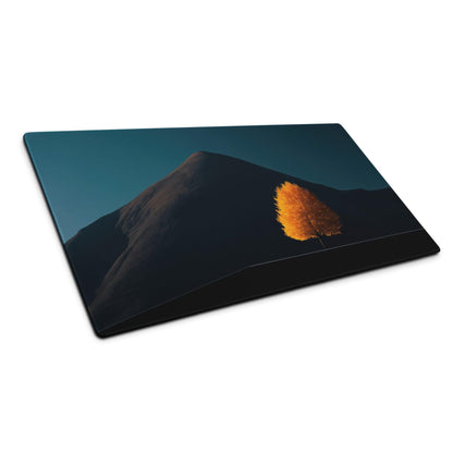 Black laptop sleeve with orange tree on dark mountain and teal sky
