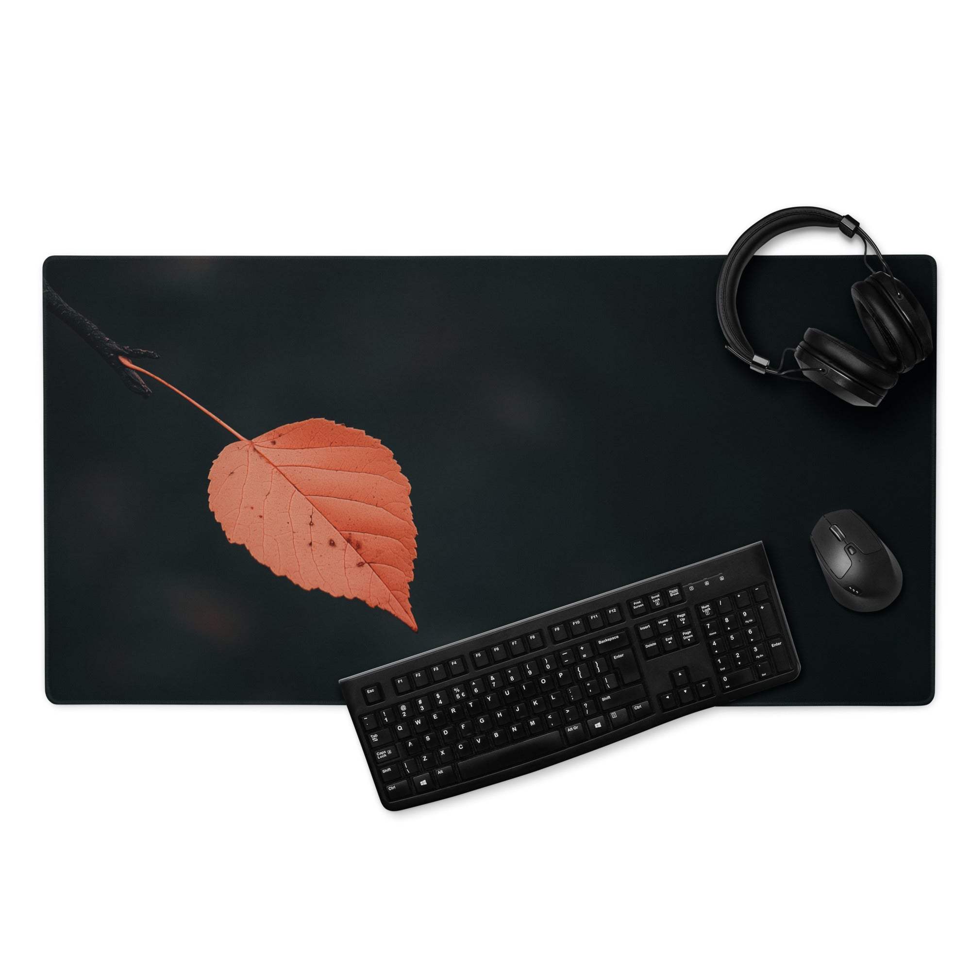 Black minimalist leaf gaming mouse pad with orange autumn leaf design