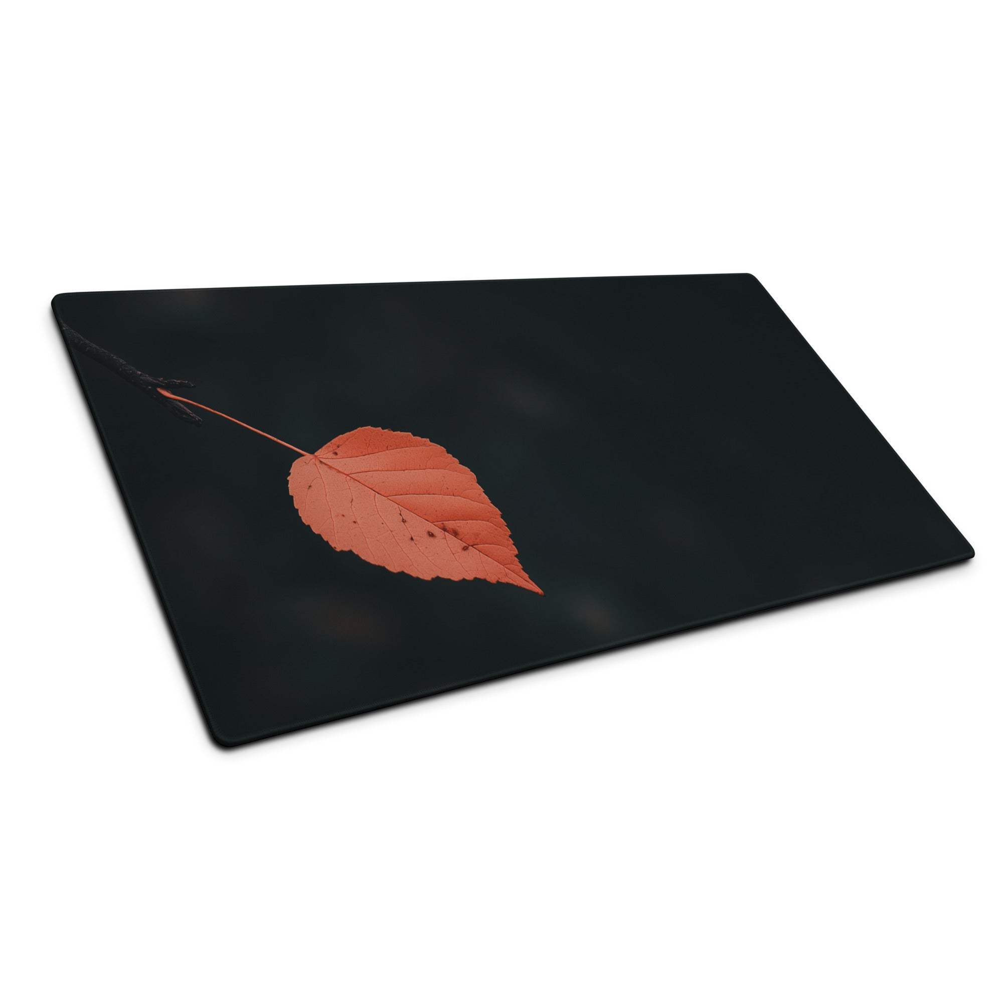 Black rectangular cutting board with orange autumn leaf print and veins