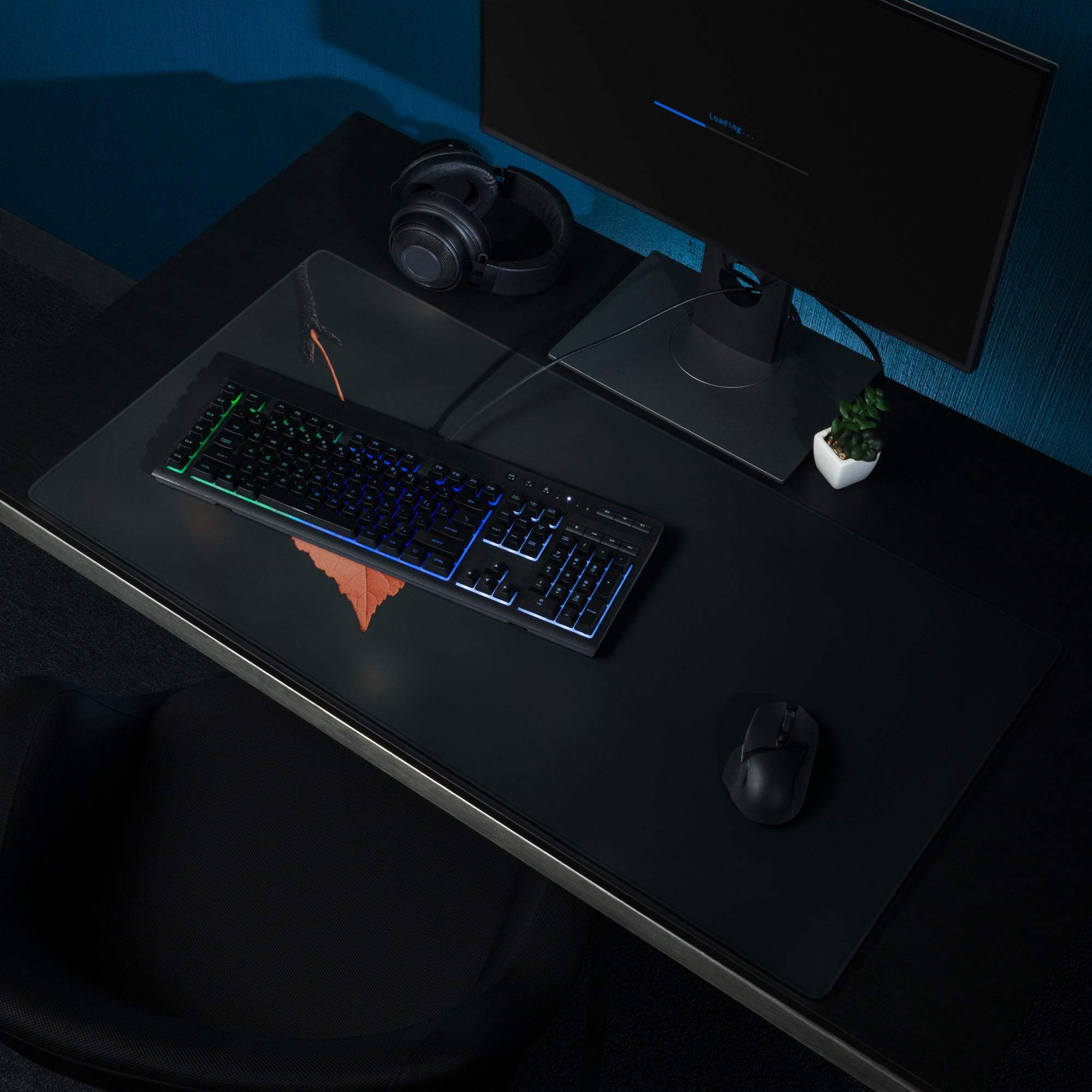 Black RGB gaming keyboard on minimalist leaf black gaming mouse pad
