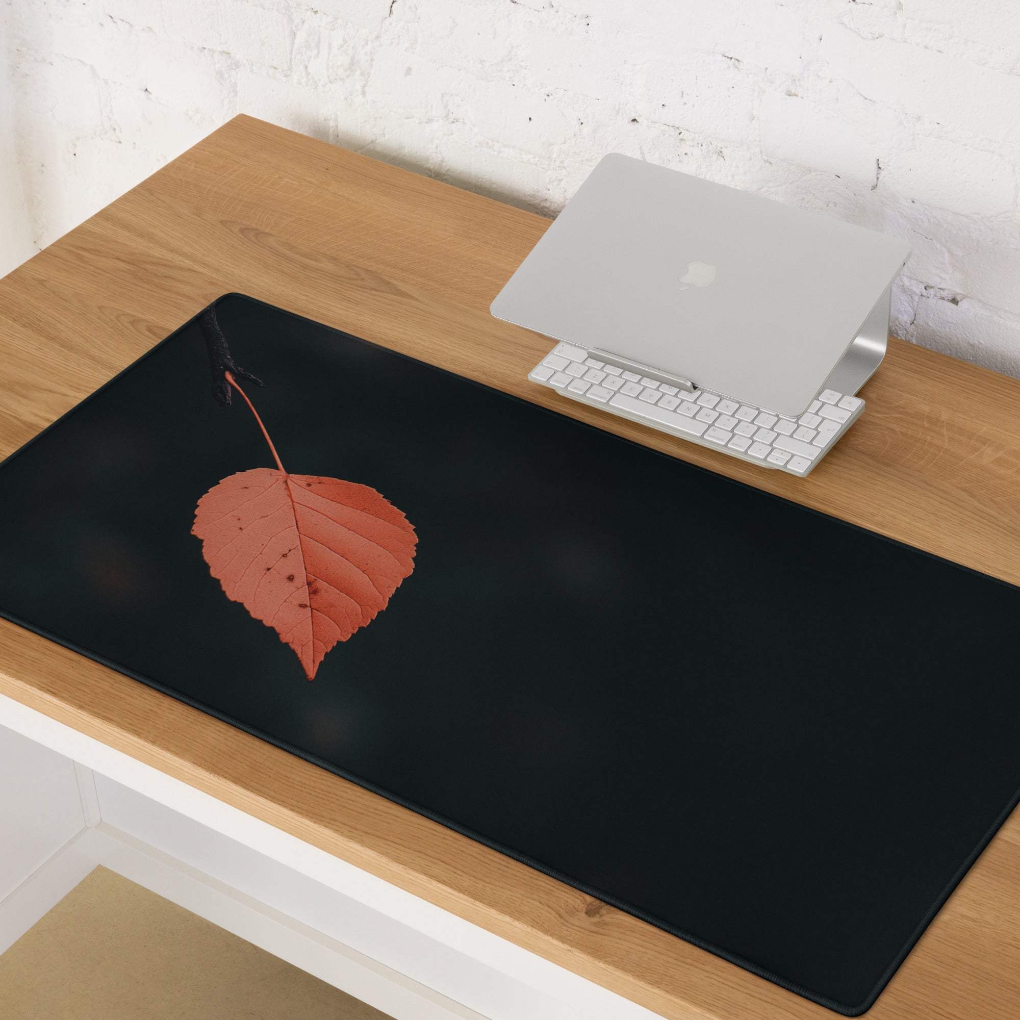 Black minimalist leaf gaming mouse pad with orange leaf design