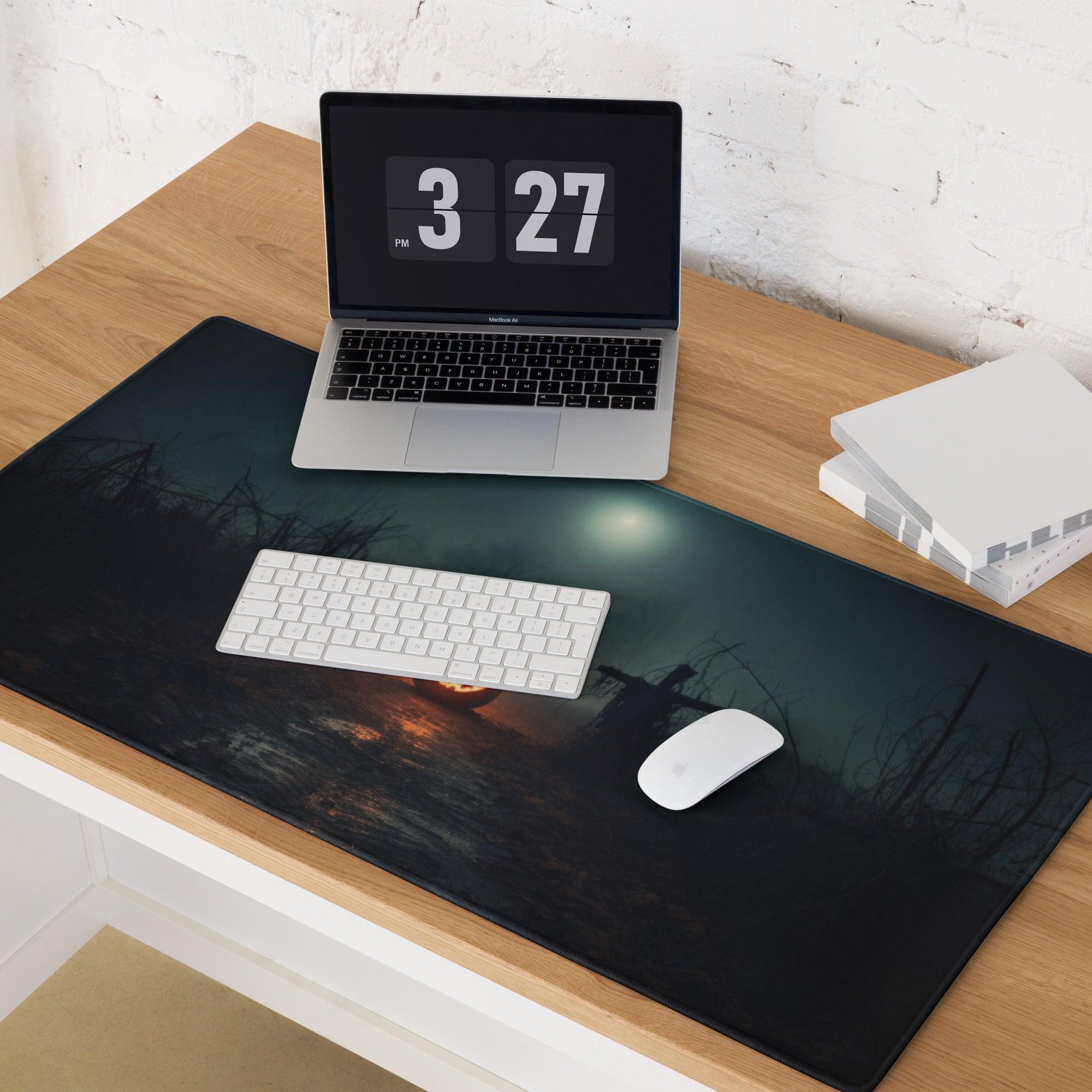 Black rectangular gaming mousepad with silhouetted forest, orange pumpkin glow