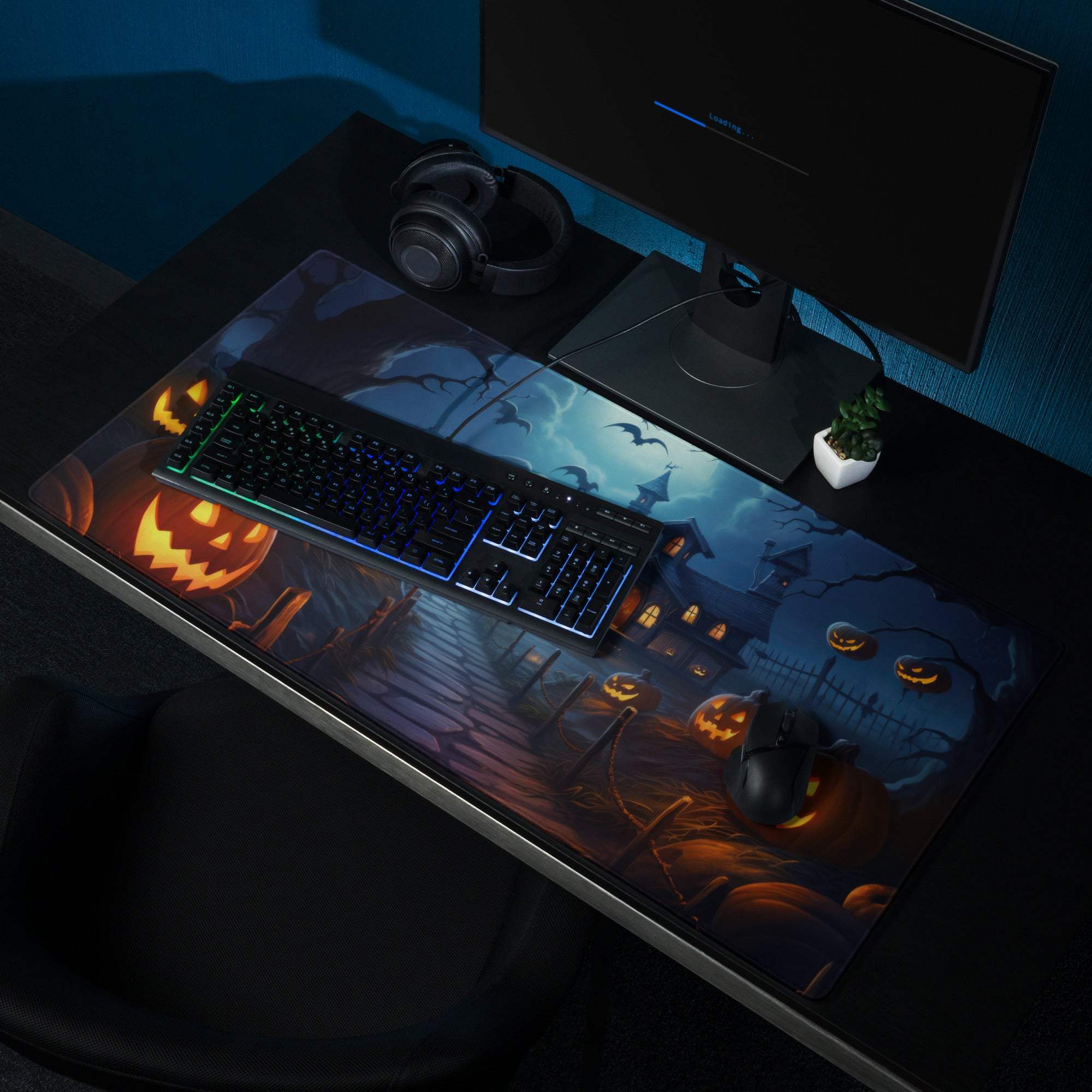 Spooky Halloween gaming mouse pad with glowing jack-o-lanterns and haunted houses