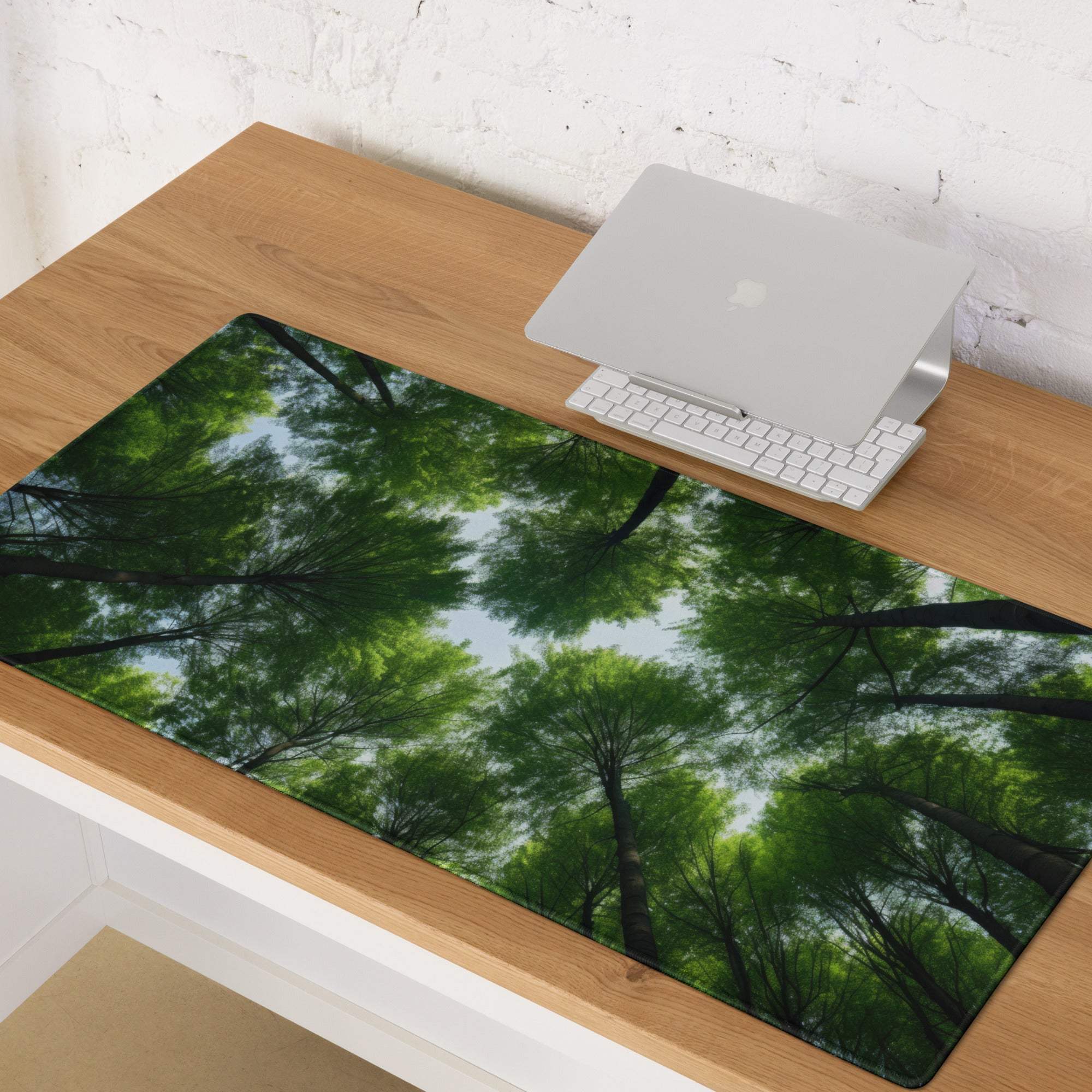 Large forest canopy gaming mouse pad on wooden surface