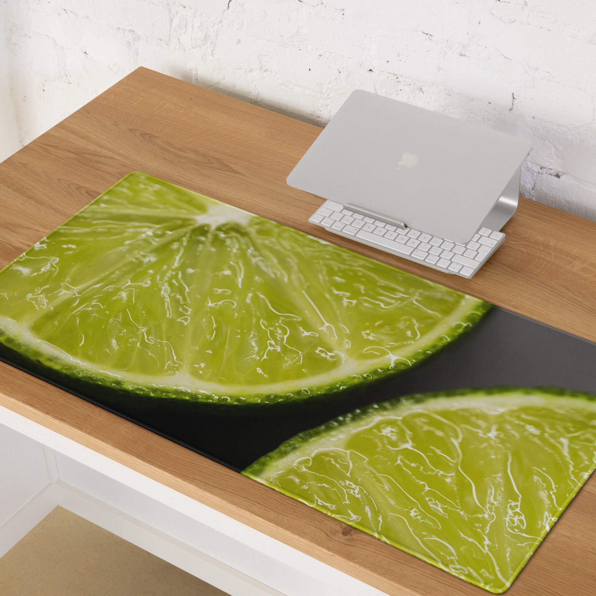 Vibrant green lime slice on large gaming mouse pad with stitched edges