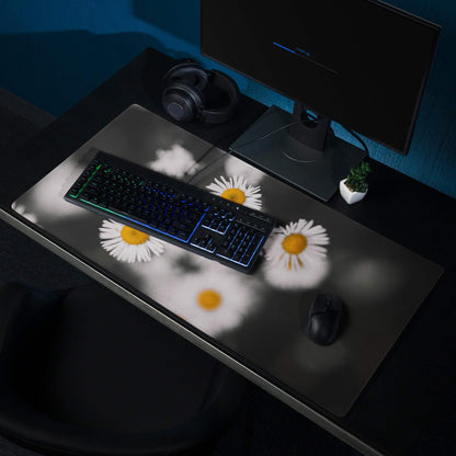 Black mousepad with white daisies, yellow centers, non-slip base, edge stitching