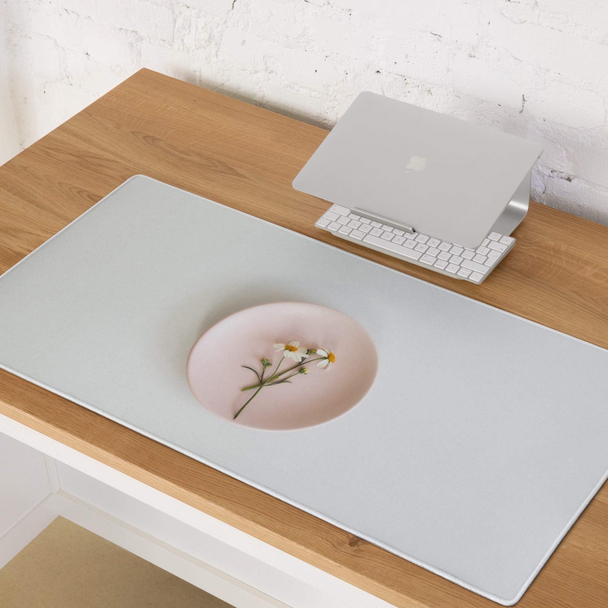 Sleek gray gaming mousepad with pink flower bowl indentation