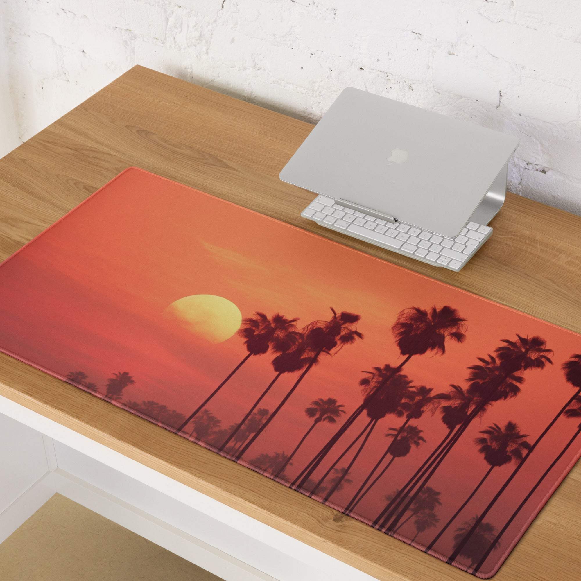 Vibrant sunset palm trees orange gaming mouse pad on wooden desk