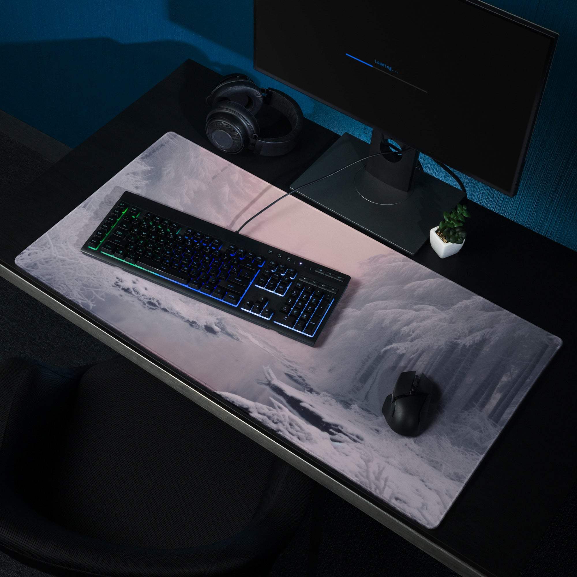 Grayscale mountain mousepad under keyboard mouse on dark desk