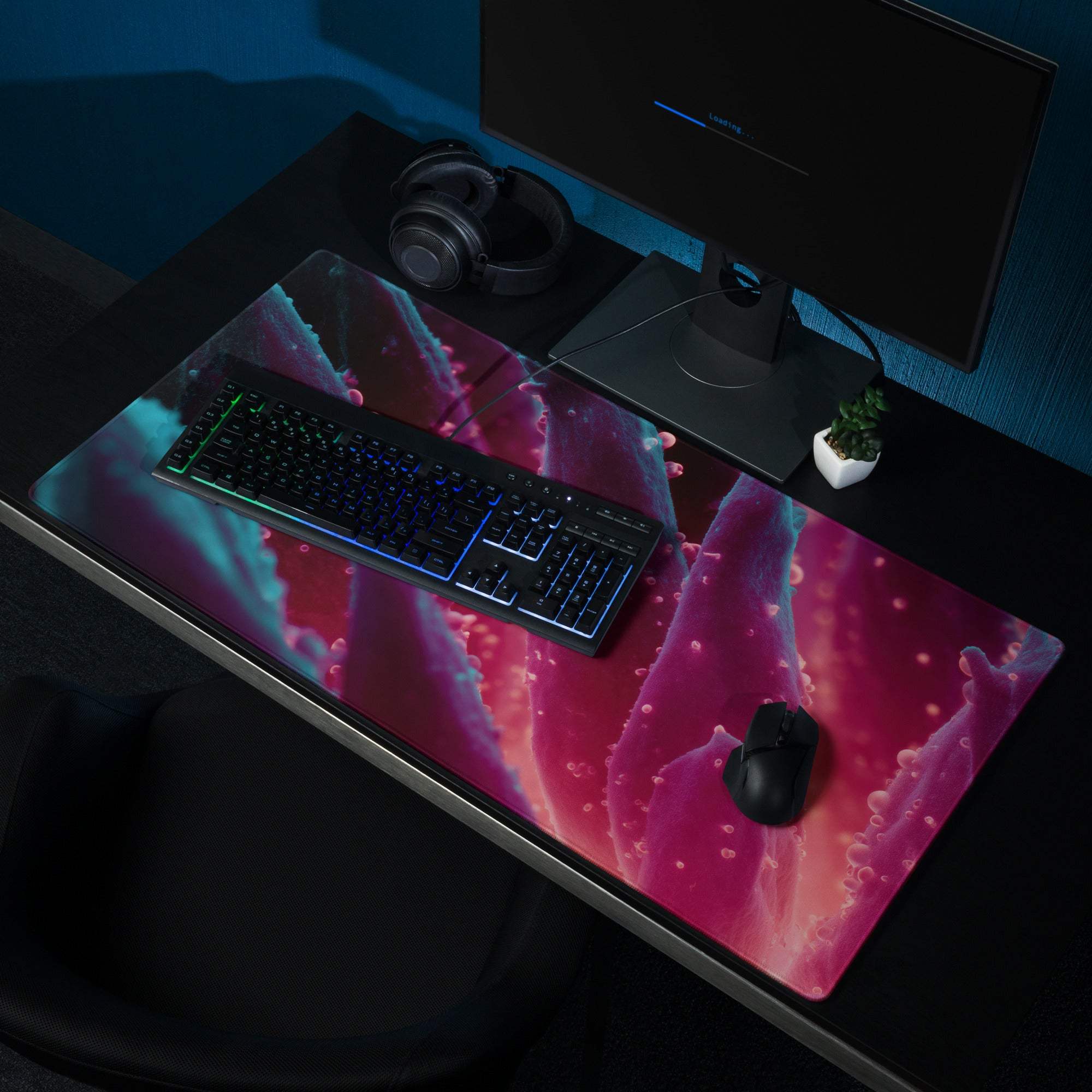 Vibrant pink teal neon gradient gaming mousepad with non-slip base stitching