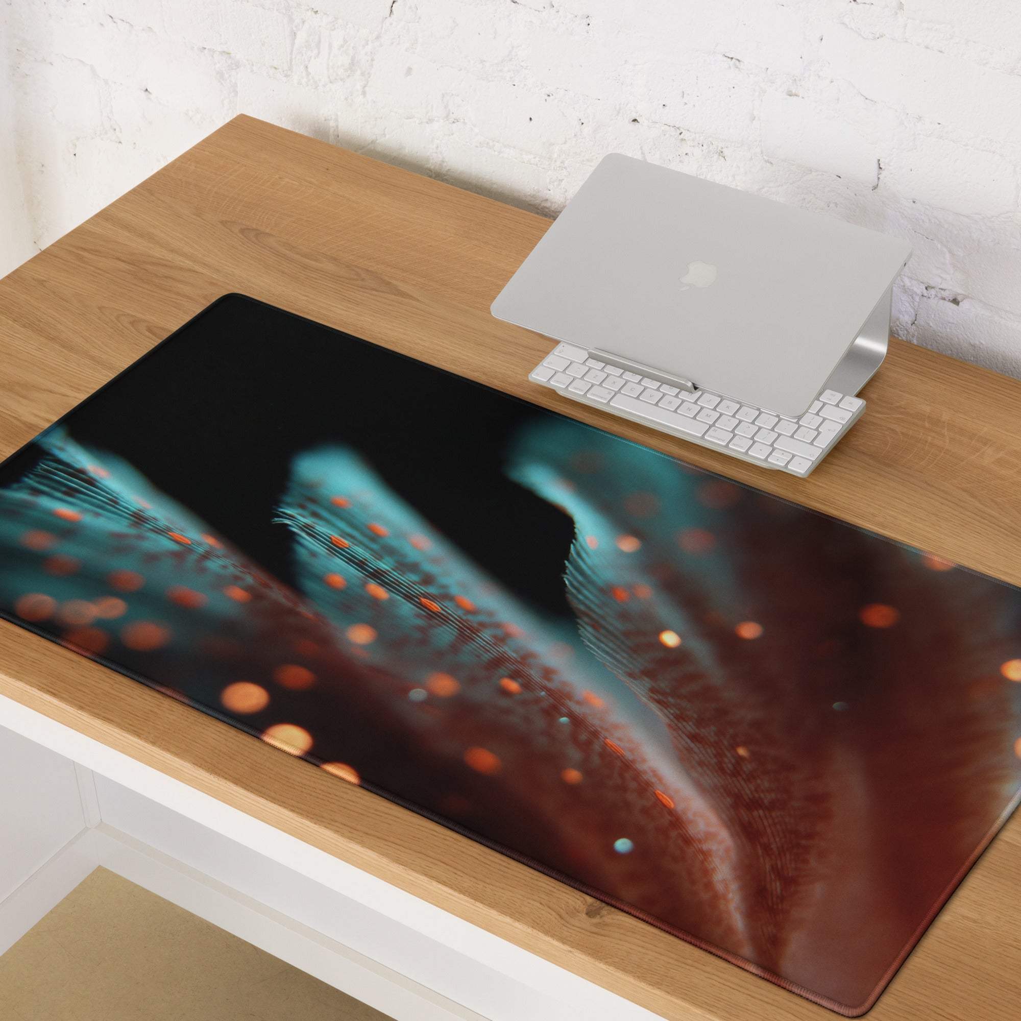 Large extended gaming mouse pad with teal orange cosmic glow design