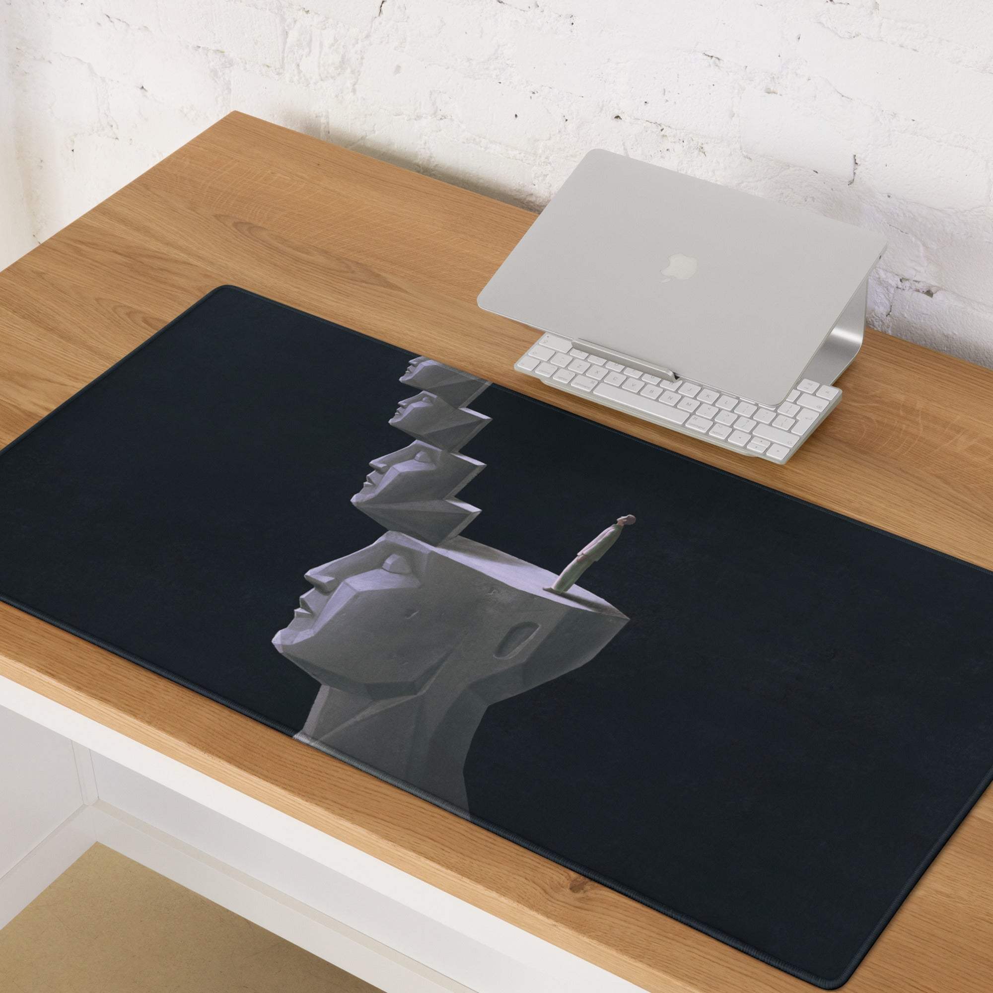 Black rectangular mouse pad with grayscale geometric heads illustration featuring a knife for gaming desk use