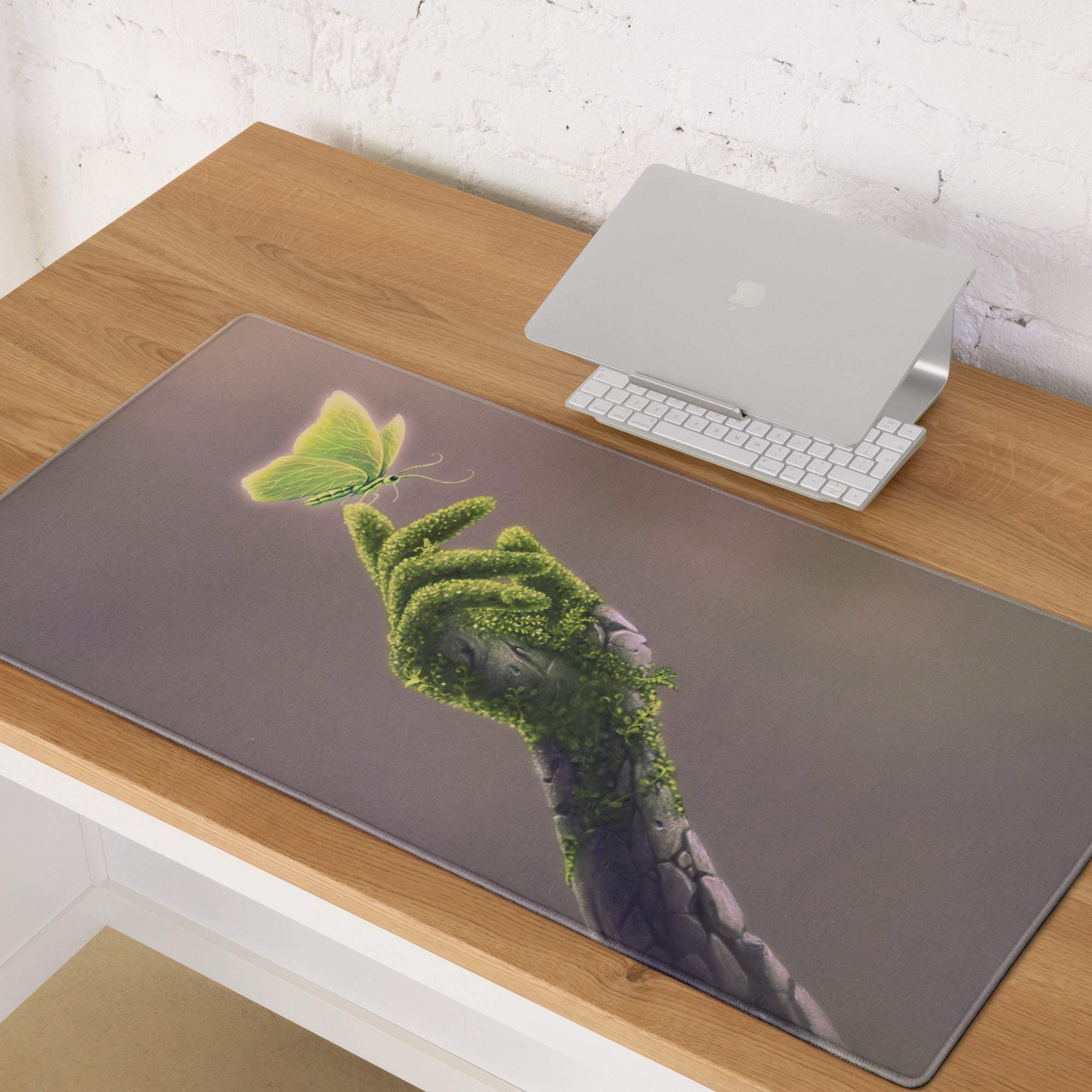 Rectangular gray polyester mousepad featuring a green moss hand holding a lime-green butterfly botanical design