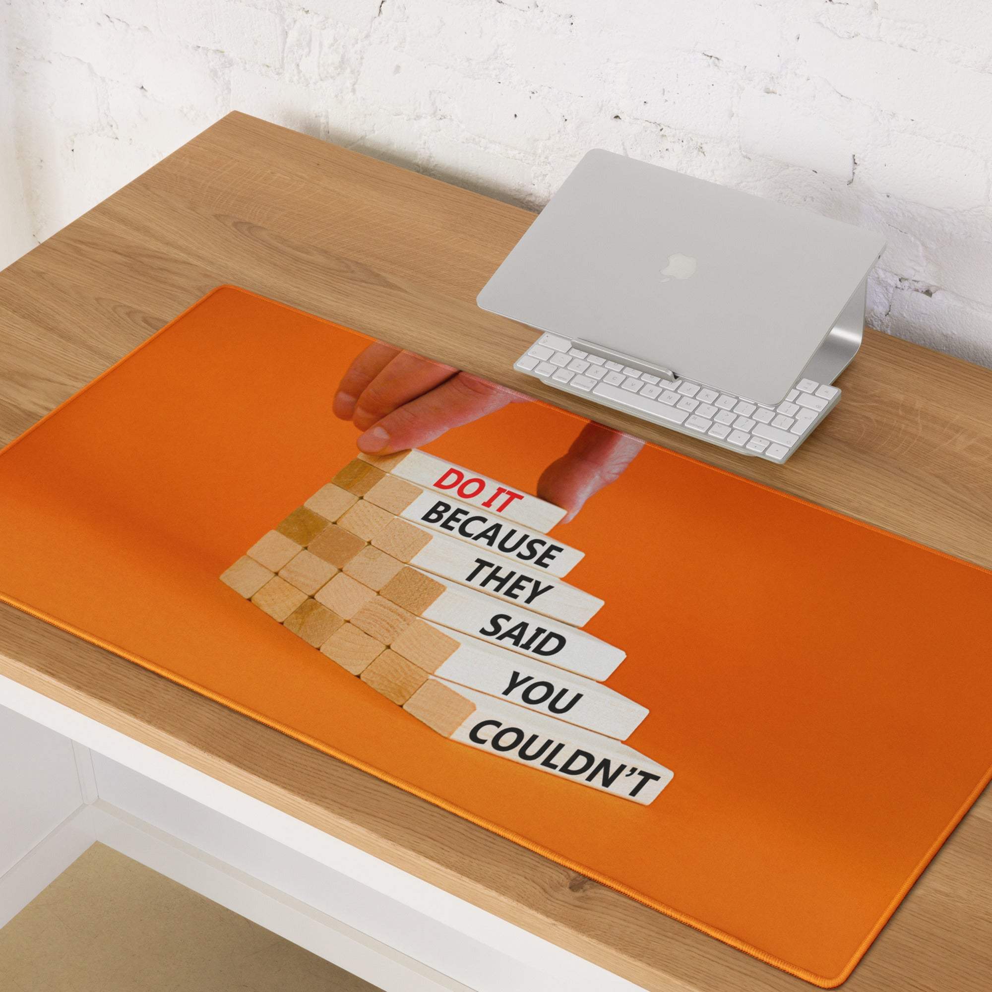 Bold orange motivational mouse pad with stacked wooden blocks and black and red text do it because they said you couldnt