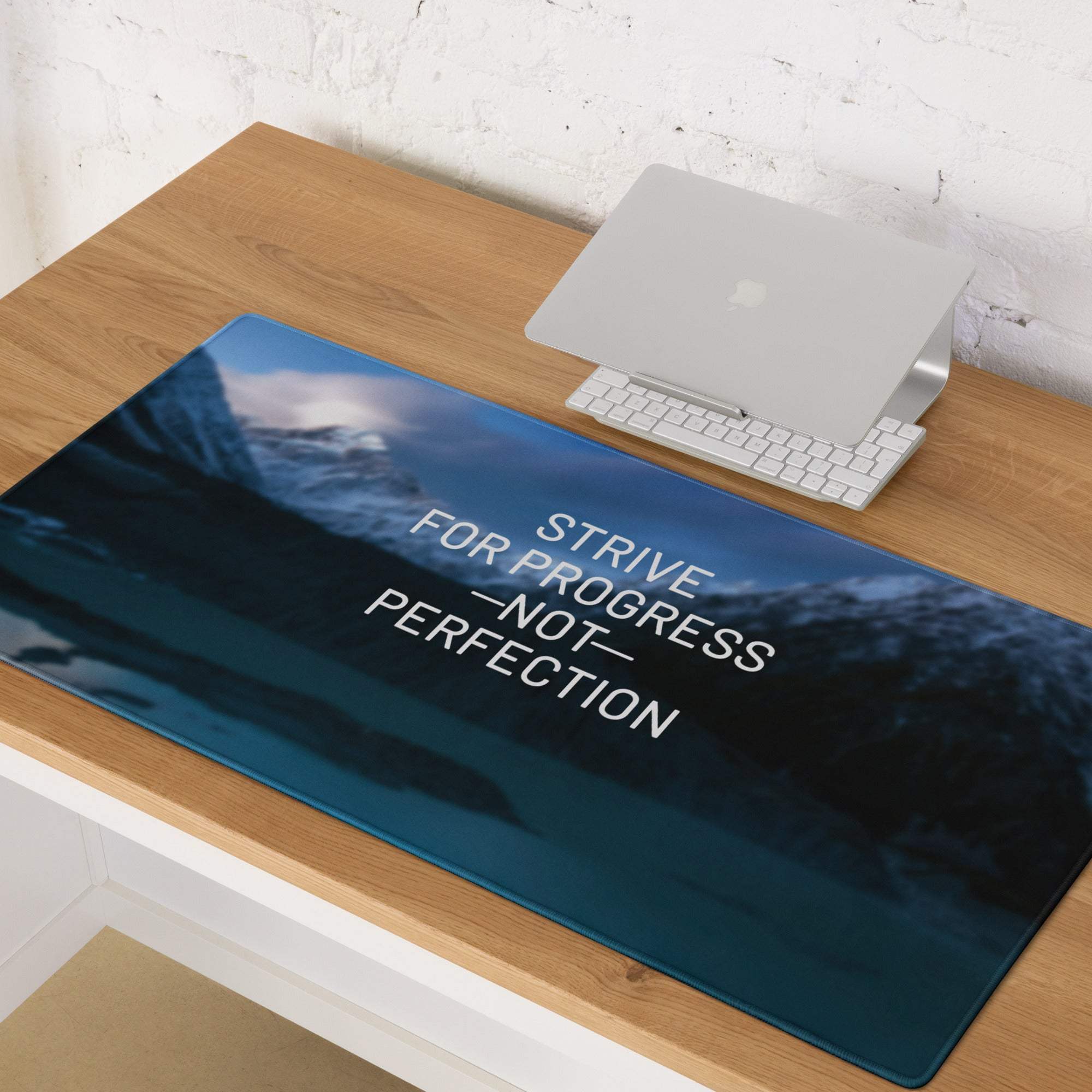 Blue mountain motivational desk pad with white strive for progress not perfection text and digital print design