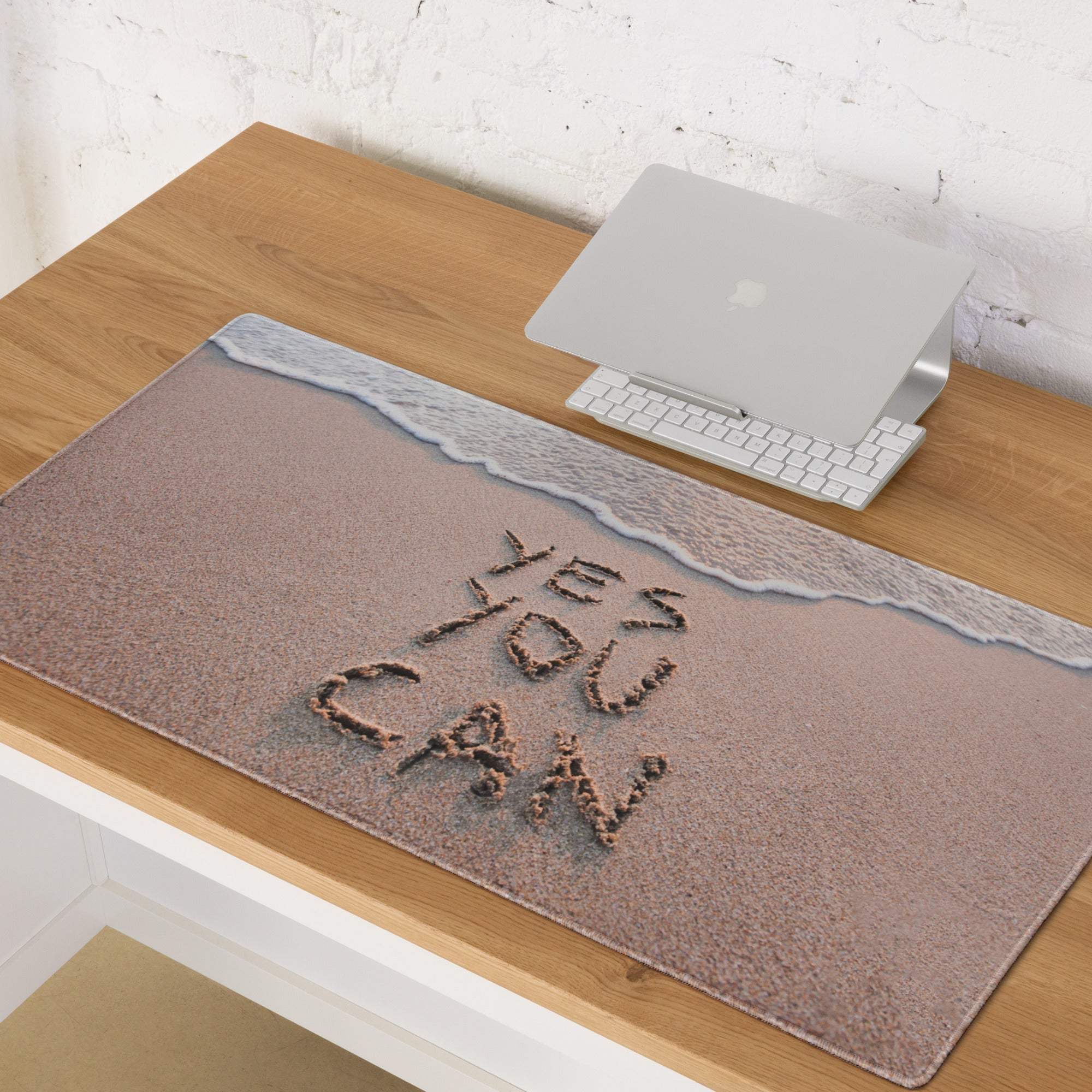 Beige textured non slip mouse pad with beach scene yes you can written in sand and ocean blue wave design top edge