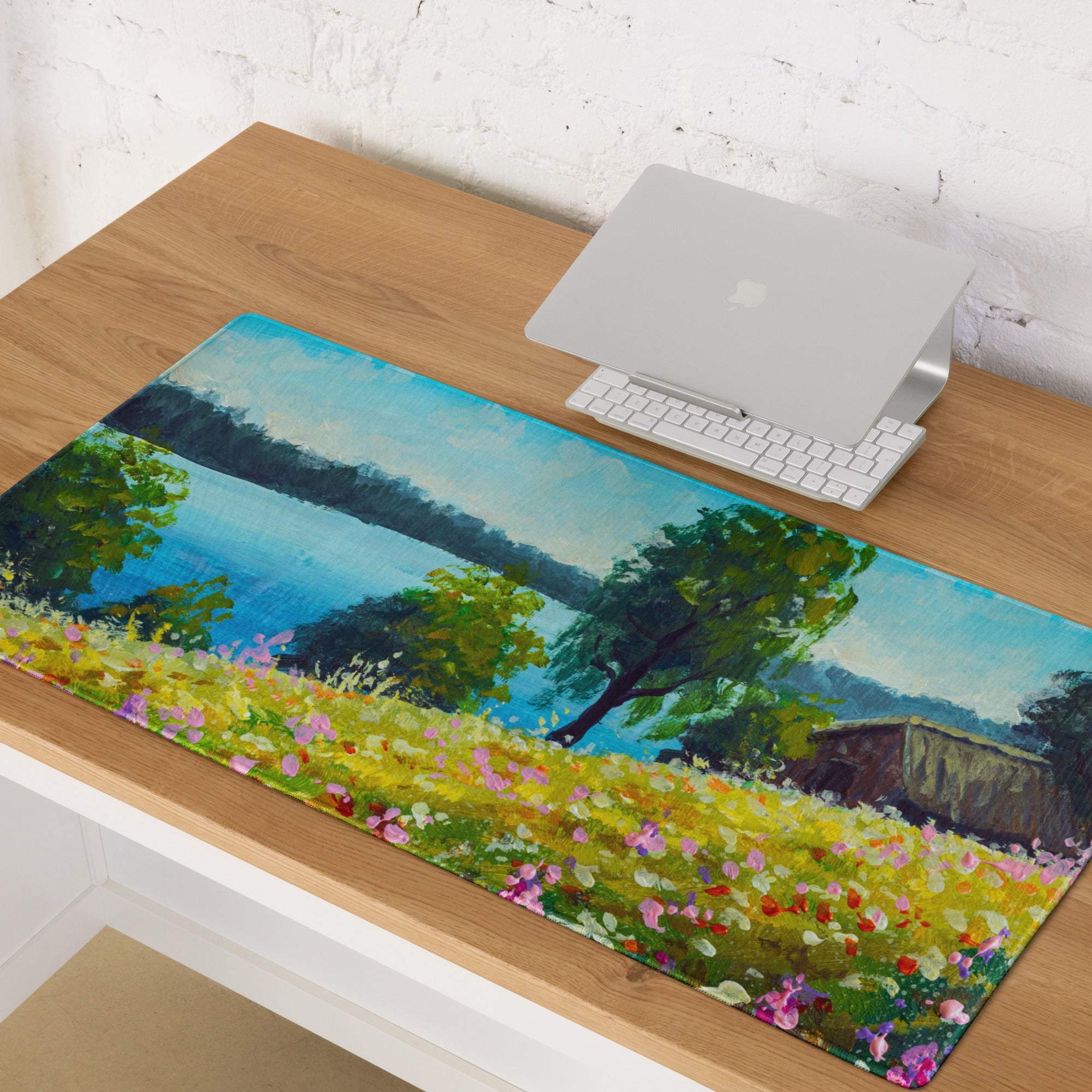 A rectangular transparent mousepad with a vibrant blue green impressionist landscape garden design for gamers