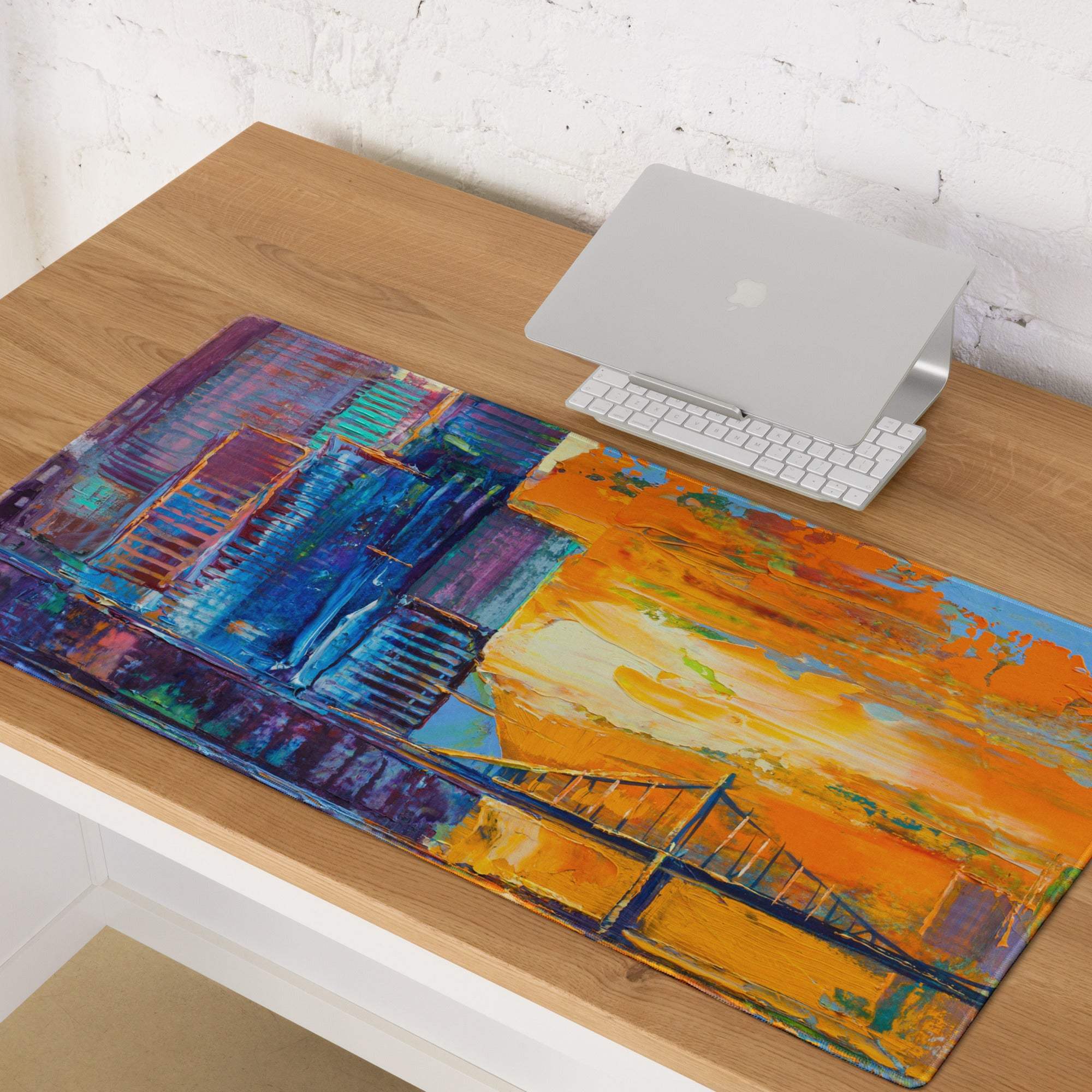 Colorful abstract cityscape gaming mouse pad with bold blue orange brushstrokes and stylized bridge design on acrylic