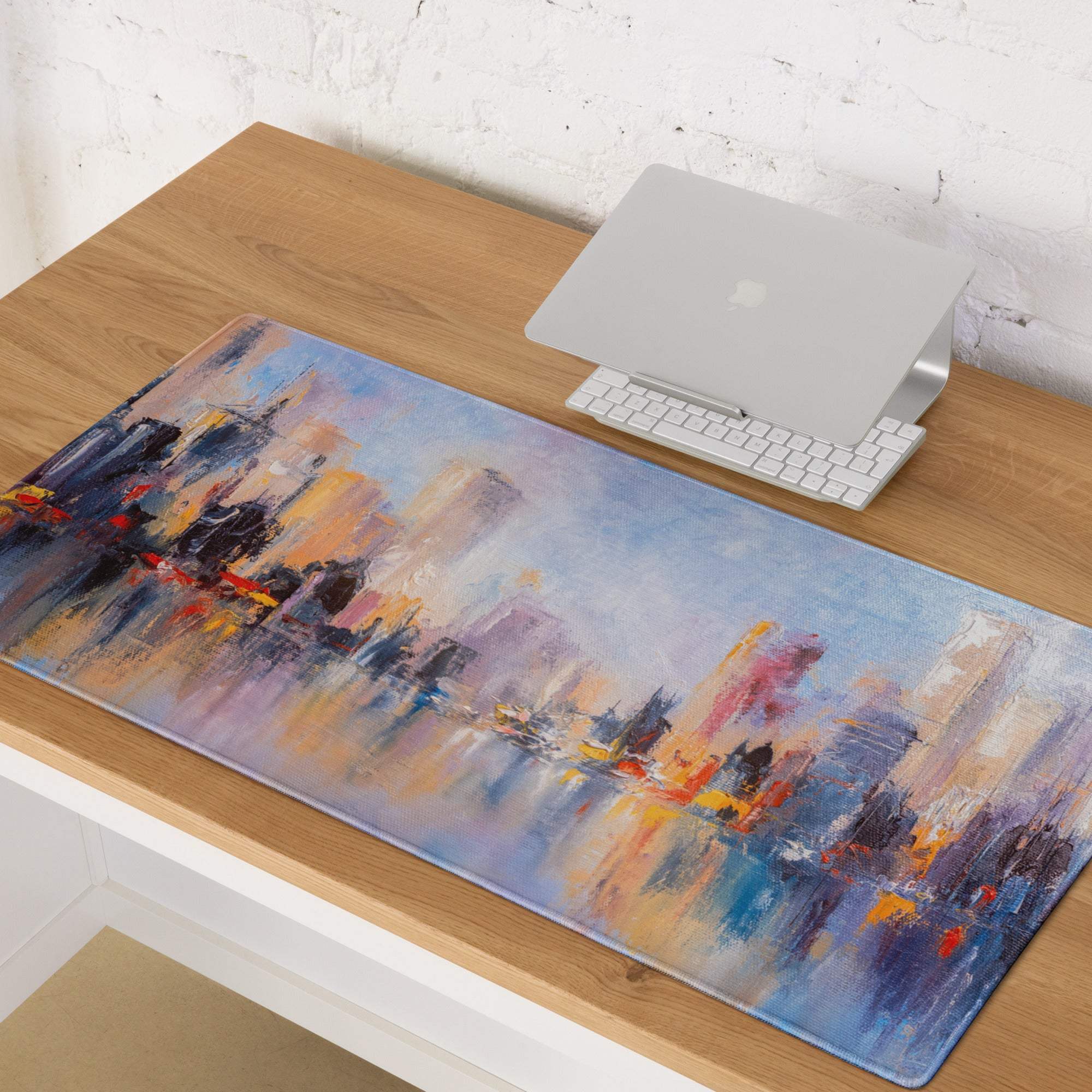 A rectangular soft textured mouse pad with an abstract cityscape design in blue purple orange and gray hues