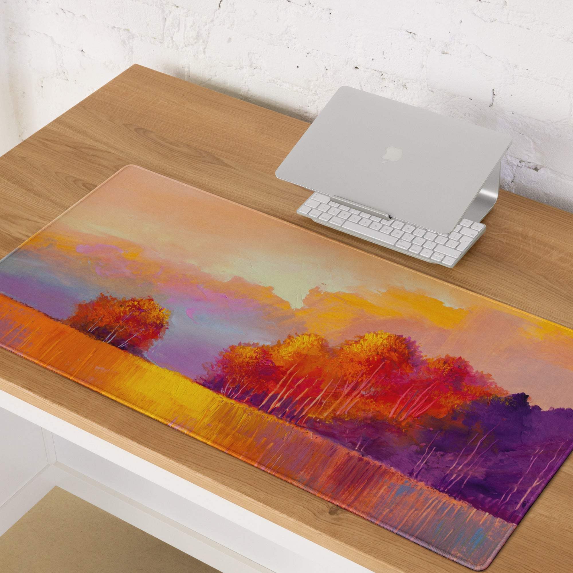 Clear rectangular mousepad featuring a vibrant autumn sunset landscape in orange purple and yellow for gaming use