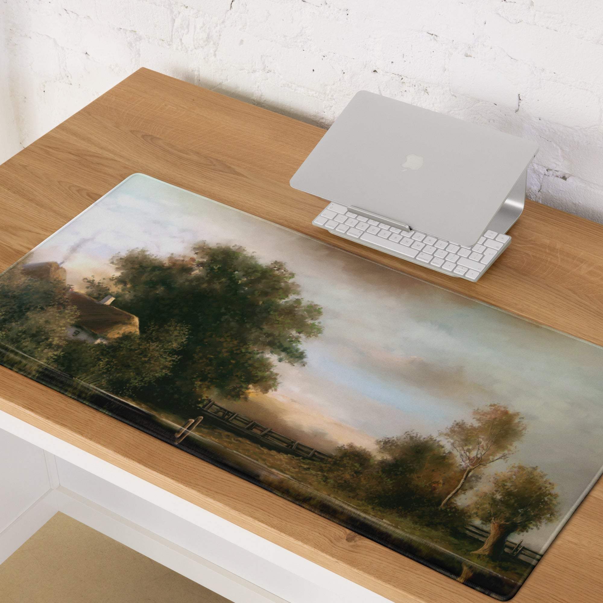 Rectangular desk mat with warm tones featuring an impressionist oil painting of a serene pastoral landscape and farm elements