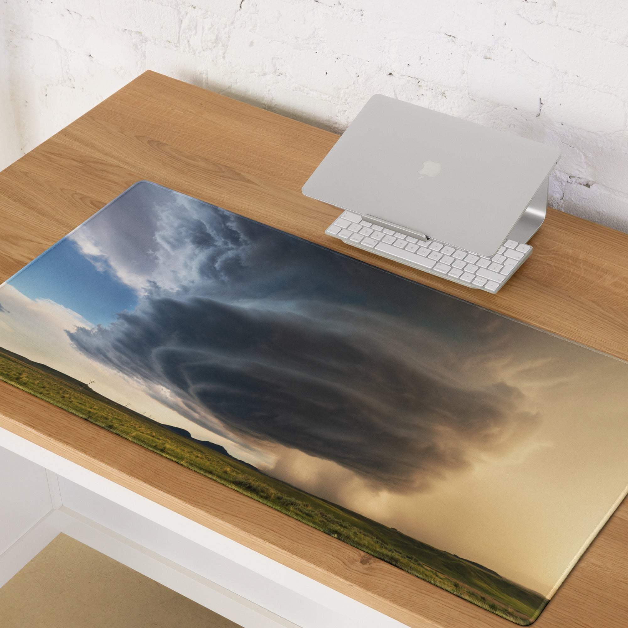 Supercell panorama gaming mouse pad with vivid storm print over green field and blue sky for modern desk setup