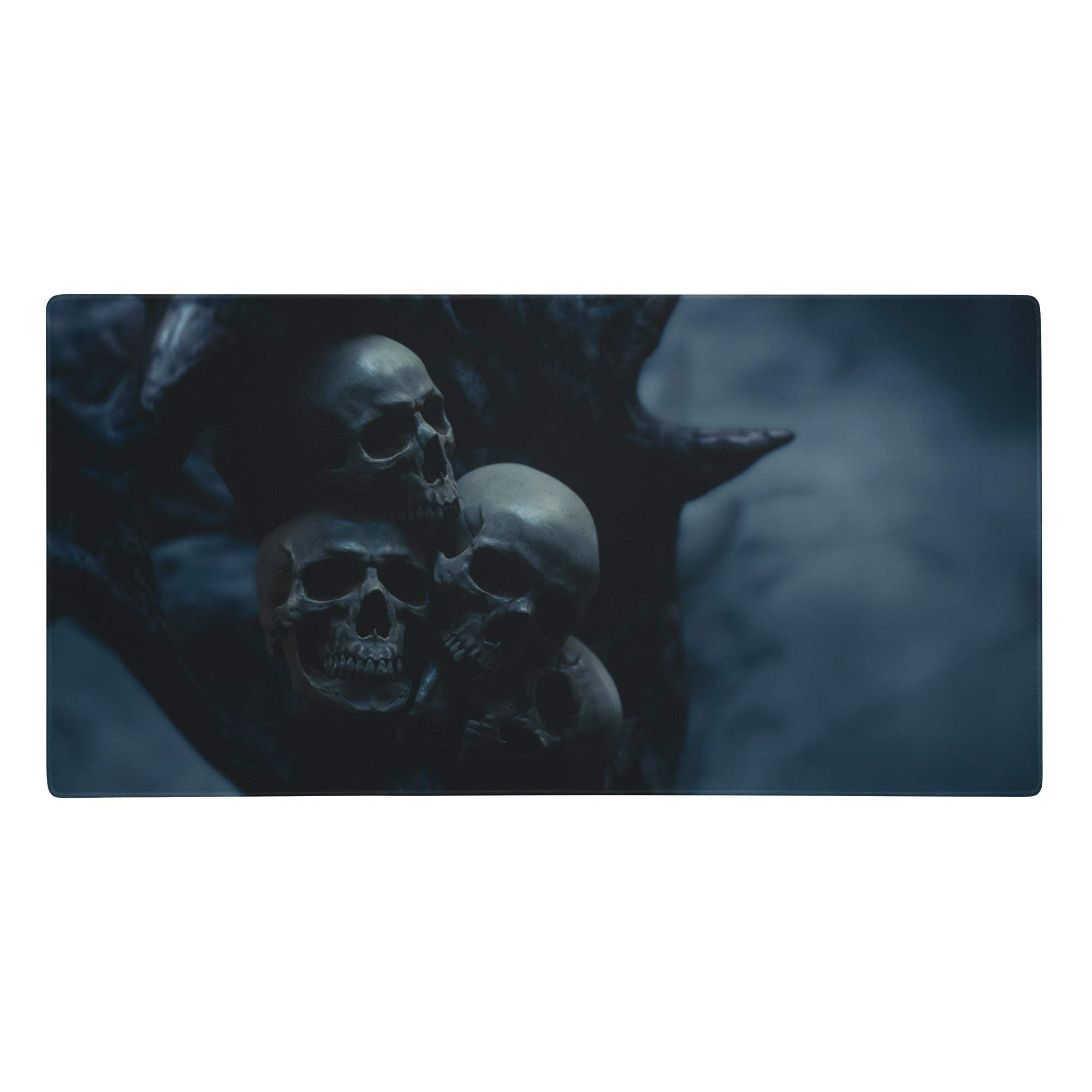 Dark blue rectangular gaming mousepad with detailed illustration of three skulls among shadowy thorny branches