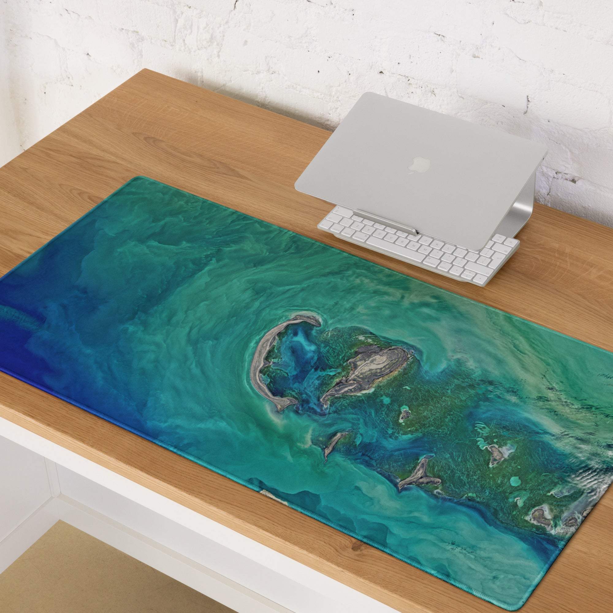 Oceanic teal gaming mouse pad with vibrant swirling oceanic design in teal and blue featuring island-like landmass