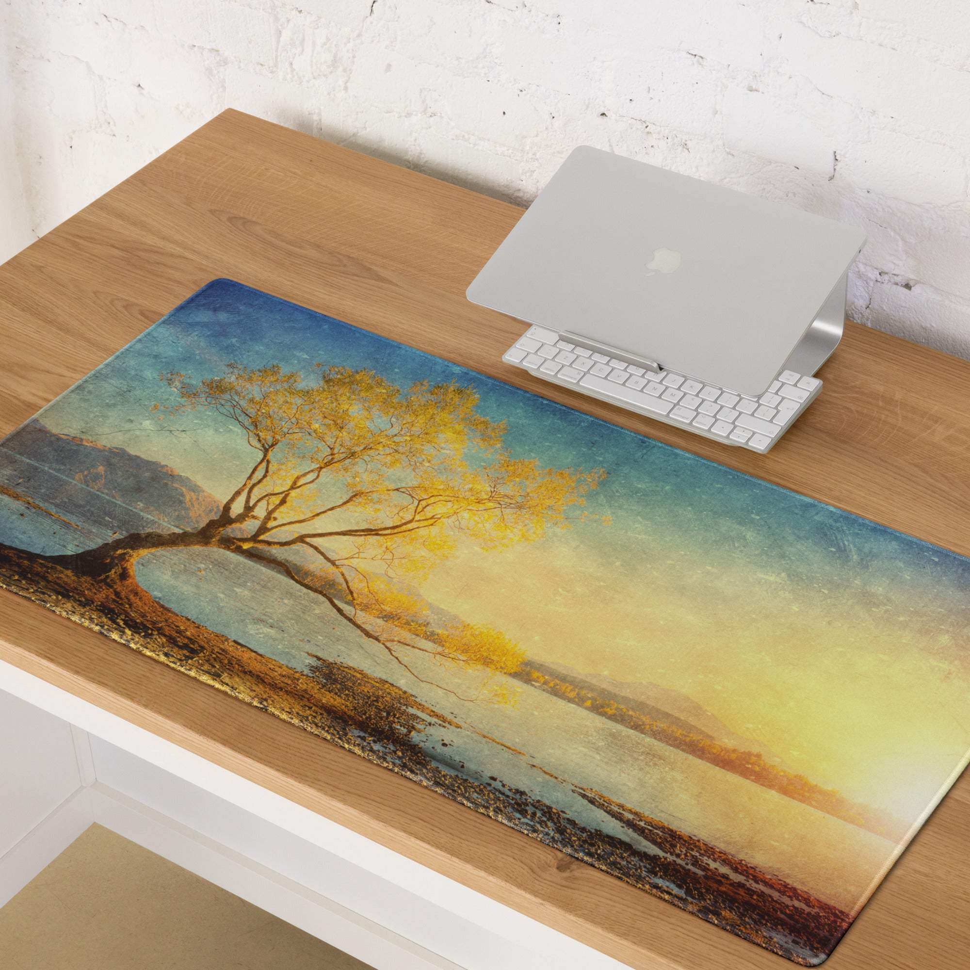Glossy rectangular mousepad featuring a serene golden autumn tree landscape with blue and yellow sunset hues