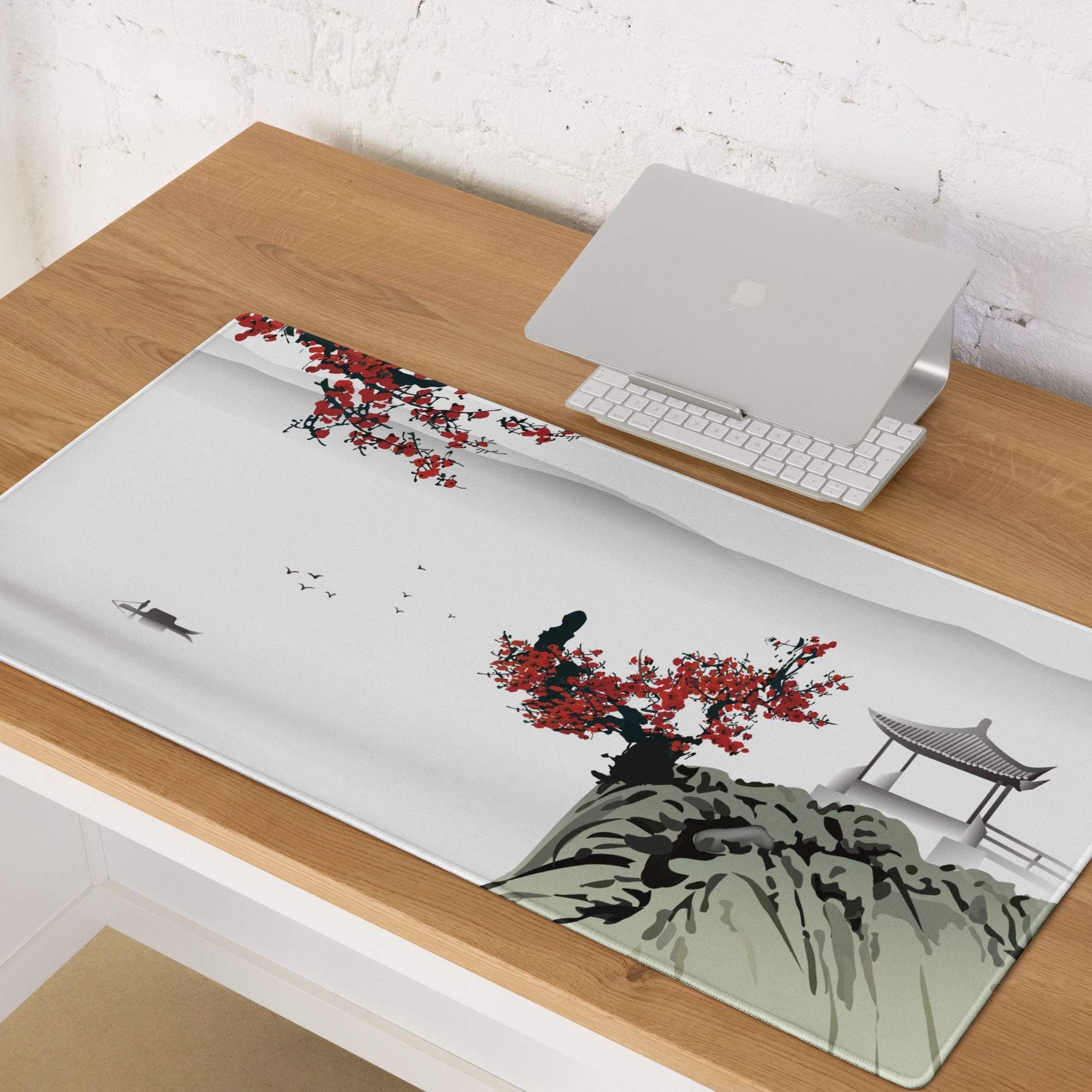 A rectangular zen blossom gaming mouse pad with red ink-wash blossoms mountains and pavilion on light gray background
