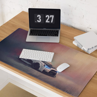 A sleek xl gaming mousepad with a white mitsubishi lancer evolution print and glowing blue headlights on carbon surface