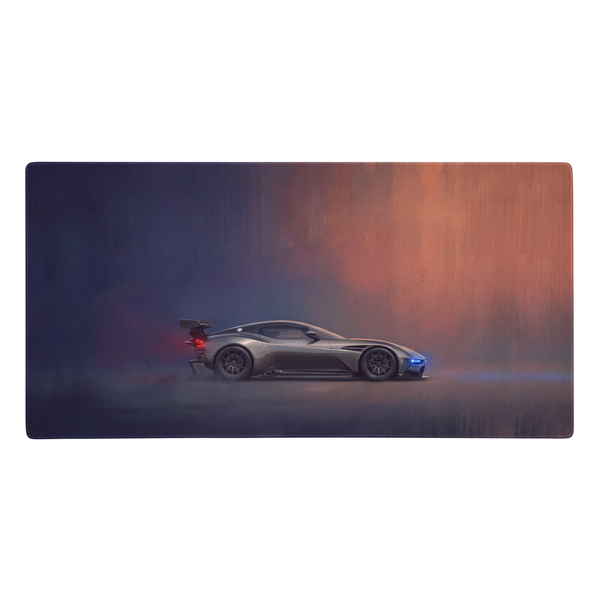 Gray aston martin valkyrie racing car on a charcoal stealth desk pad with stitched edges and atmospheric lighting effects