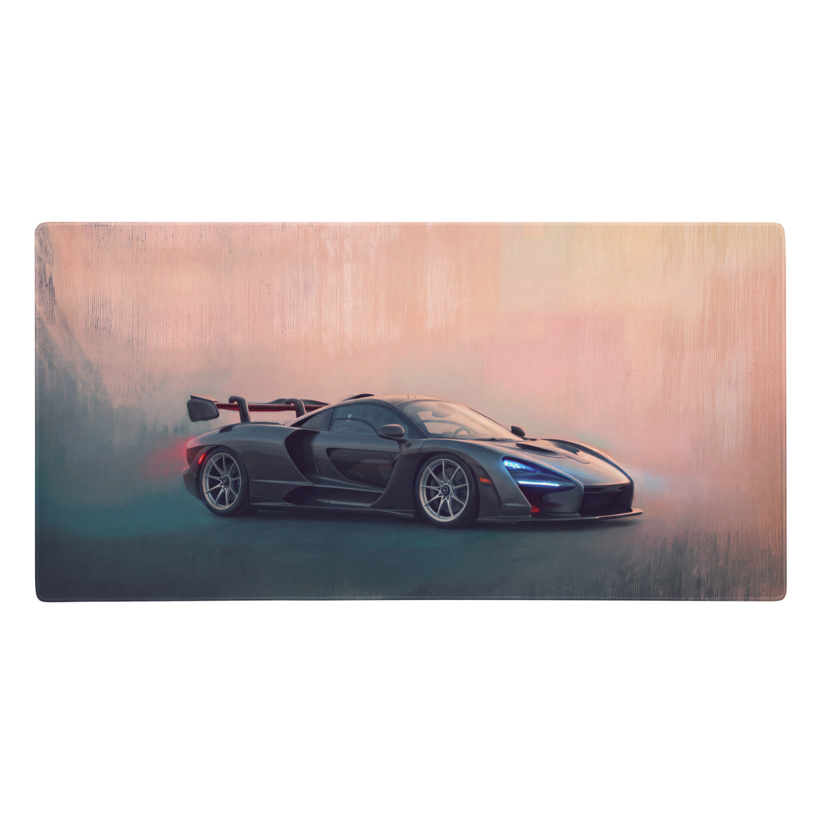 A sleek black mclaren senna inspired carbon stealth desk mat with glowing blue headlights and red rear wing accents